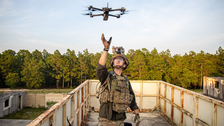 A Paratrooper playing the Opposing Force assigned to 1st Battalion, 505th Parachute Infantry Regiment, 3rd Brigade Combat Team, 82nd Airborne Division, receives a drone during Devil Avalanche, at Fort Bragg, North Carolina, July 22, 2025. Devil Avalanche is a field training exercise where Paratroopers train to operate in periods of darkness, build proficiency on key weapon systems, and sustain the force throughout the exercise. (U.S. Army B-Roll package by Sgt. Dominick Smith)