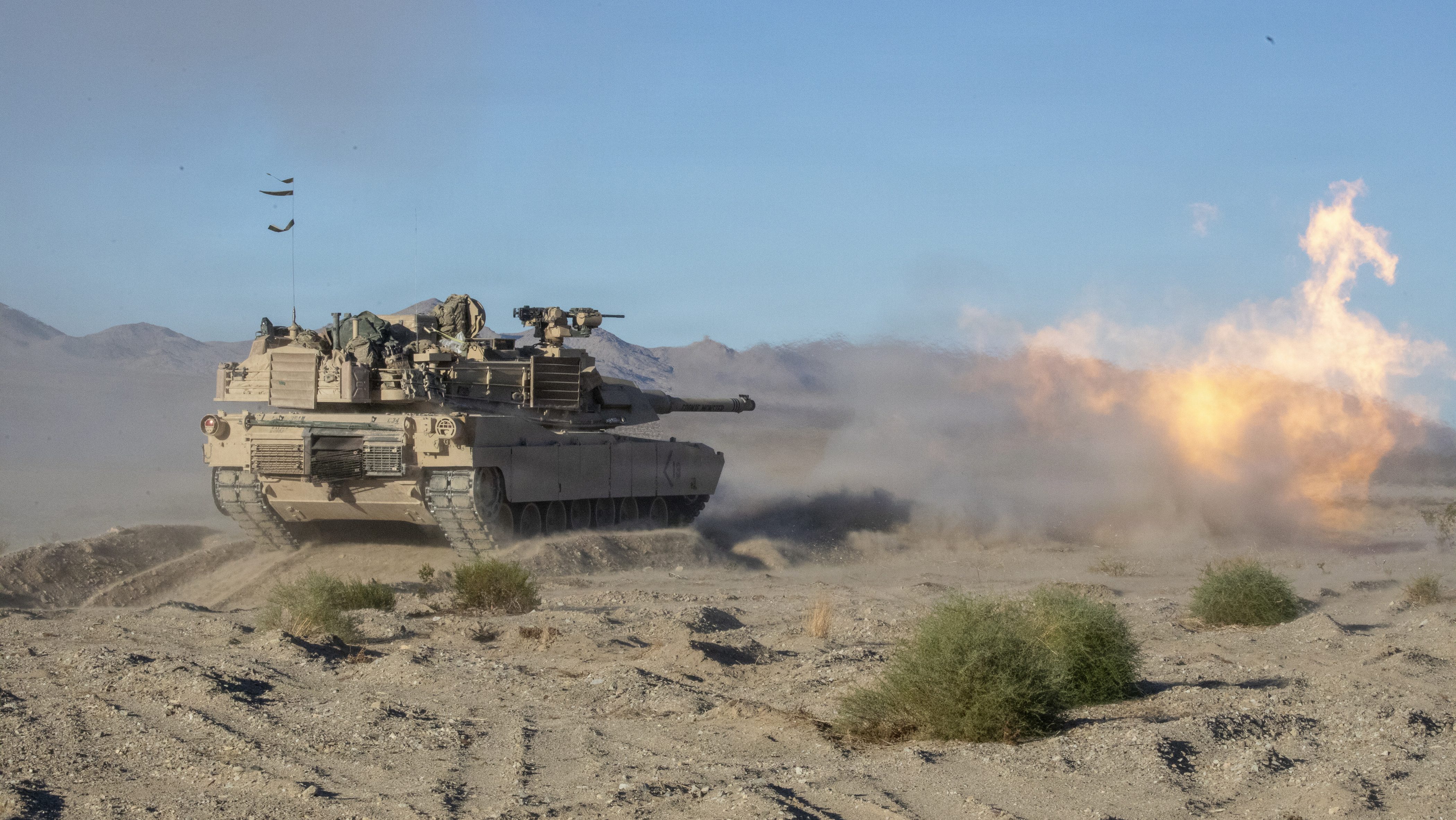 U.S. Soldiers assigned to 1st Battalion, 36th Infantry, 1st Armored Brigade Combat Team, 1st Armored Division Regiment fires a M1 Abrams main battle tank at live fire target during Rotation 26-01 at the National Training Center, Fort Irwin, Calif., Oct. 17, 2025. Rotations at the National Training Center ensure Army Brigade Combat Teams remain versatile, responsive, and consistently available for current and future contingencies. (U.S. Army photo by Cpl. Michael McClary, Operations Group, National Training Center)