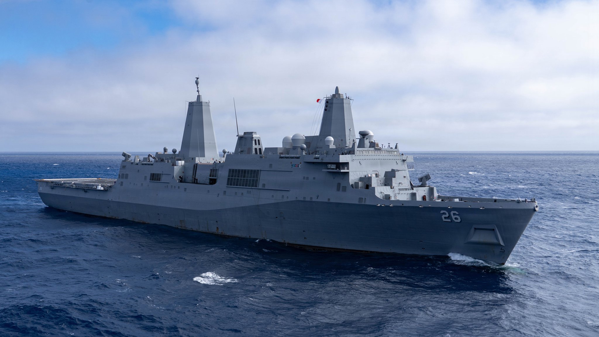 Amphibious transport dock ship USS John P. Murtha (LPD 26) steams through the Pacific Ocean, April 8, 2026. John P. Murtha is underway in the U.S. 3rd Fleet area of operations supporting NASA’s Artemis II mission, retrieving the crew and spacecraft following their return to Earth and splashdown in the Pacific Ocean. NASA’s Artemis II mission sent four astronauts on a flight around the moon in the Orion space capsule, marking the first time humans journeyed to deep space in over 50 years. (U.S. Navy photo by Mass Communication Specialist 2nd Class Kenneth Melseth)