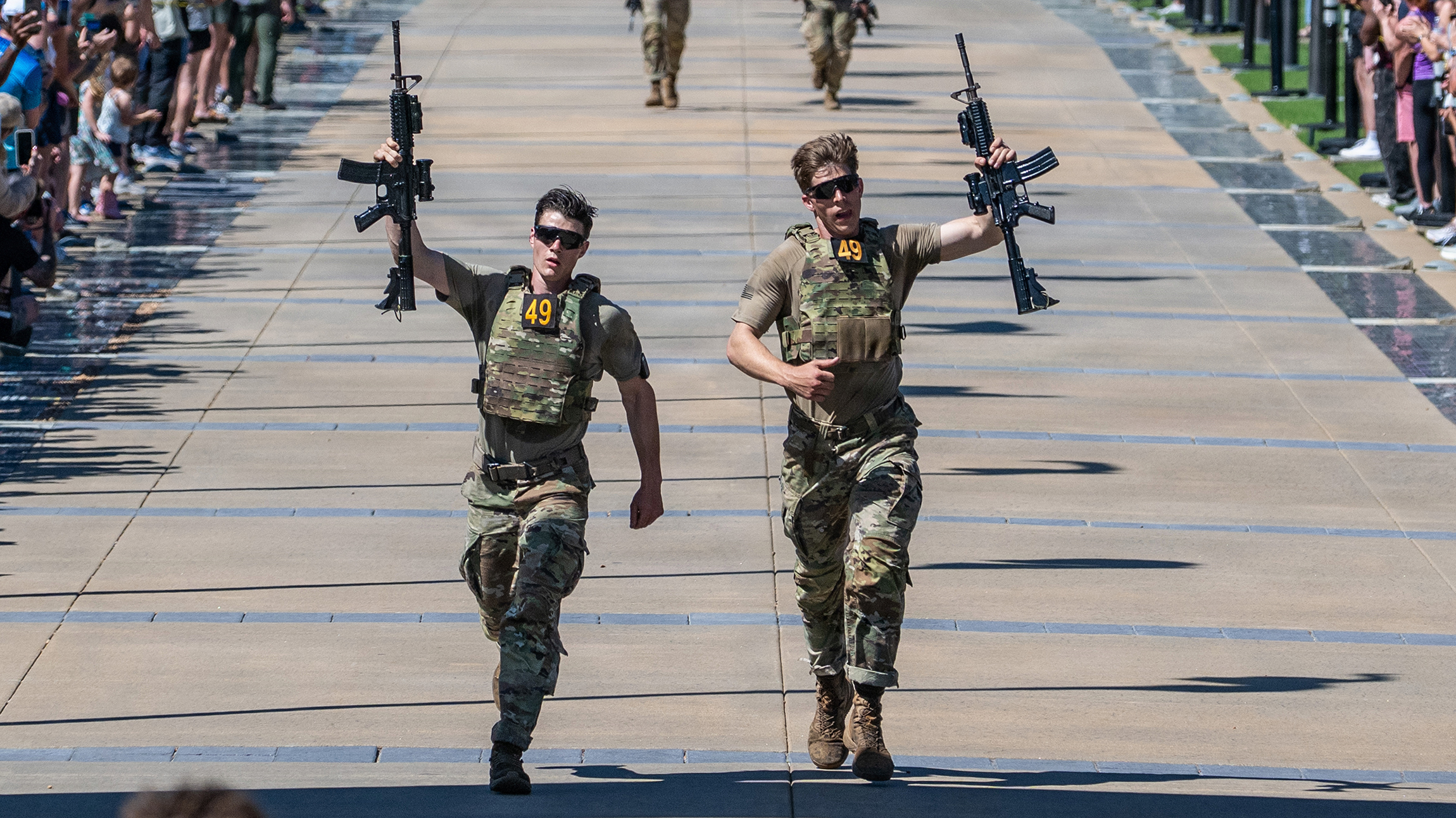 Two Army Rangers competing in an obstacle course during the Best Ranger Competition.