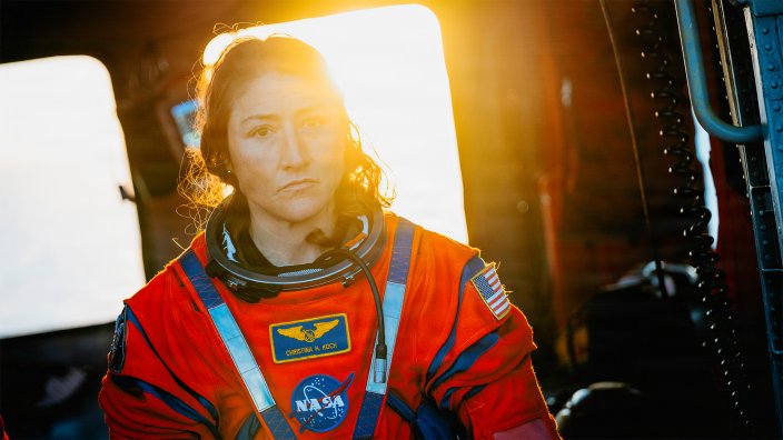 NASA astronaut Christina Koch sits in an U.S. Navy MH-60S Seahawk attached to Helicopter Sea Combat Squadron (HSC) 23 on the flight deck of the San Antonio Class amphibious transport dock USS John P. Murtha (LPD 26) after returning from space on Apr. 10, 2026.