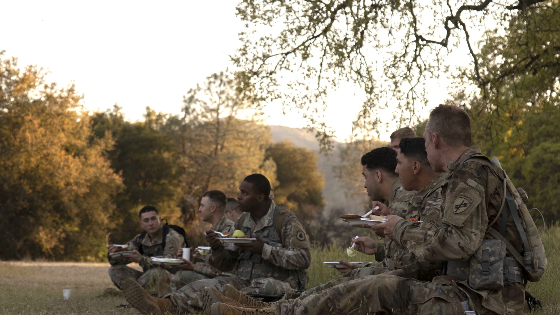 Image: A group of soldier competitors eat dinner in the field after completing a land navigation course during the 2022 Combined Best Warrior Competition at Fort Hunter-Liggett, California, April 1. 15 Soldiers traveled to compete in this year’s Best Warrior, hosted by United States Army Civil Affairs and Psychological Operations Command (Airborne), 84th Training Command, and 108th Training Command (IET) from March 31 through April 5, 2022. Competitors are evaluated on their individual ability to adapt and overcome challenging scenarios and battle-focused events, which test their technical and tactical abilities under stress and extreme fatigue. (U.S. Army Reserve photo by Spc. Olivia Cowart)