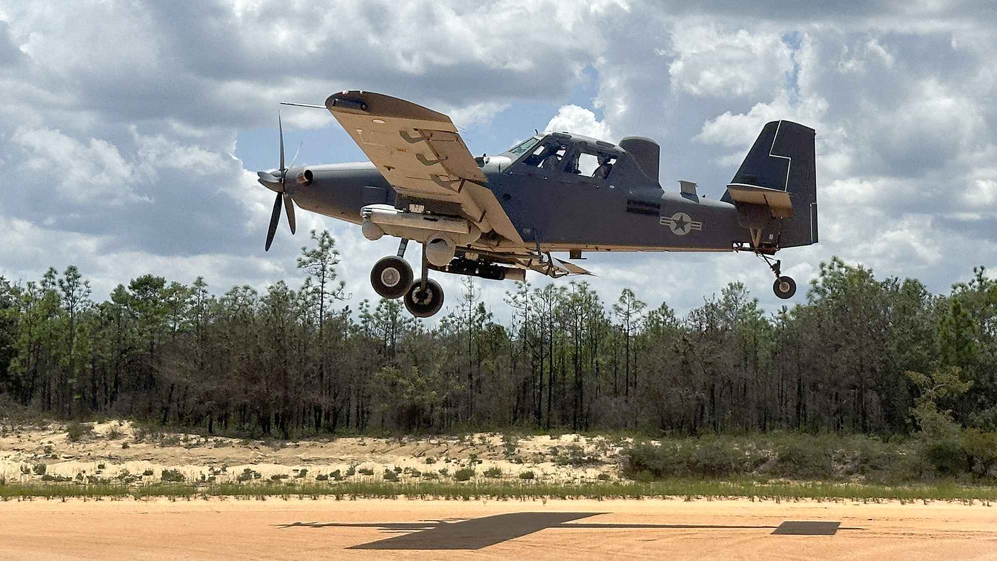 An OA-1K Skyraider II comes in for a landing on a dirt path July 10 on the Eglin Air Force Base, Florida range. The new Air Force Special Operations Command aircraft continues developmental testing with the 96th Test Wing and the U.S. Special Operations Command at Eglin. (Courtesy image)