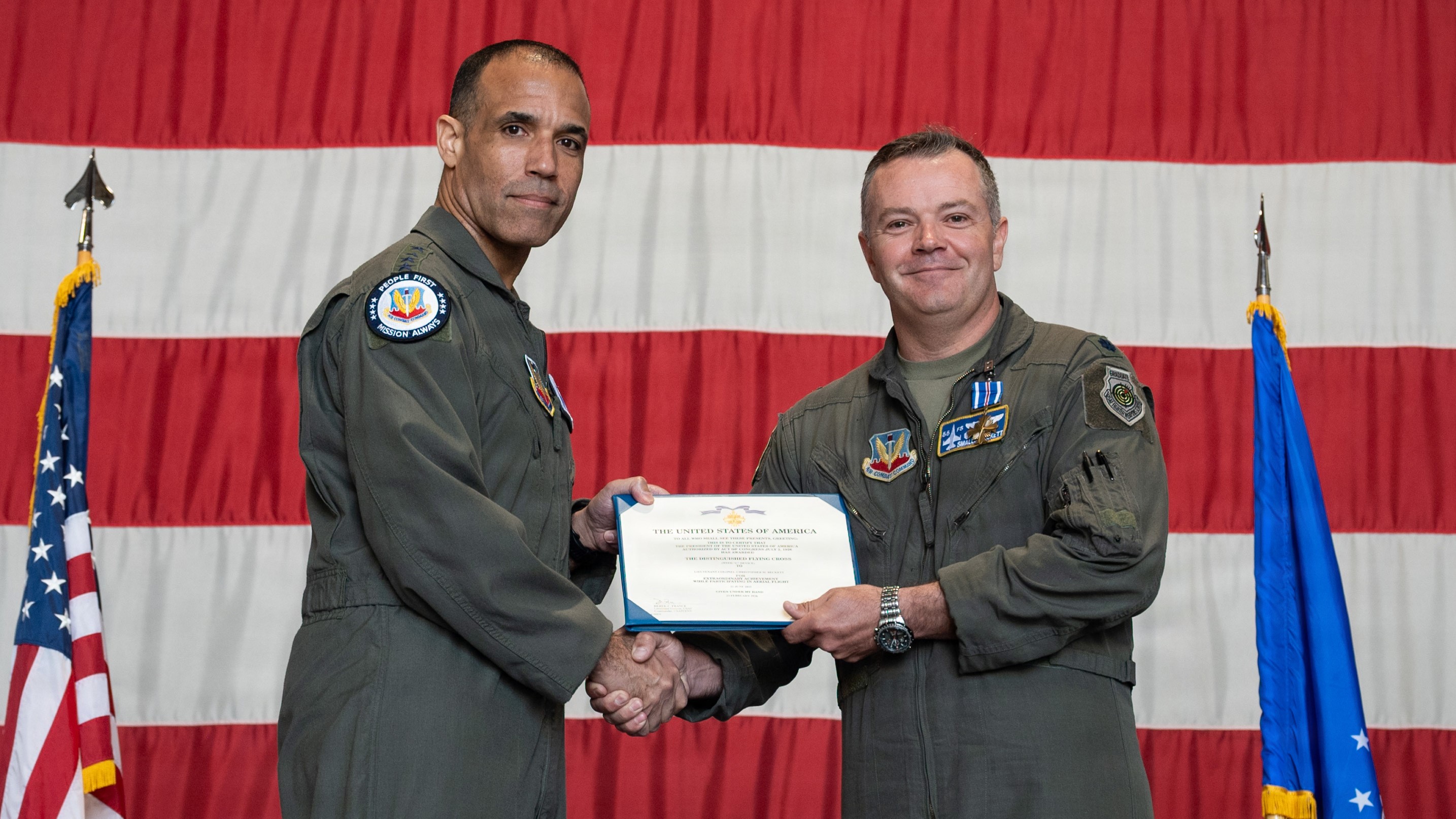 U.S. Air Force Gen. Adrian Spain, commander of Air Combat Command, presents Lt. Col. Christopher M. Beckett, an F-16 Fighting Falcon pilot and 55th Fighter Squadron commander, with the Distinguished Flying Cross during a ceremony at Shaw Air Force Base, South Carolina, May 5, 2026. Beckett received the decoration for the heroism and bravery he exemplified while flying during Operation Midnight Hammer. (U.S. Air Force photo by Senior Airman Nyanda Walker-Potts) 