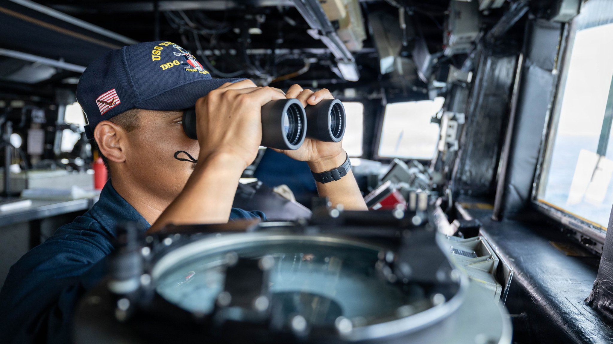 A U.S. Sailor stands watch in the pilot house of the Arleigh Burke-class guided-missile destroyer USS Truxtun (DDG 103), May 18, 2026. Truxtun is deployed to U.S. 5th Fleet area of operations to support maritime security and stability in the Middle East. (U.S. Navy photo)