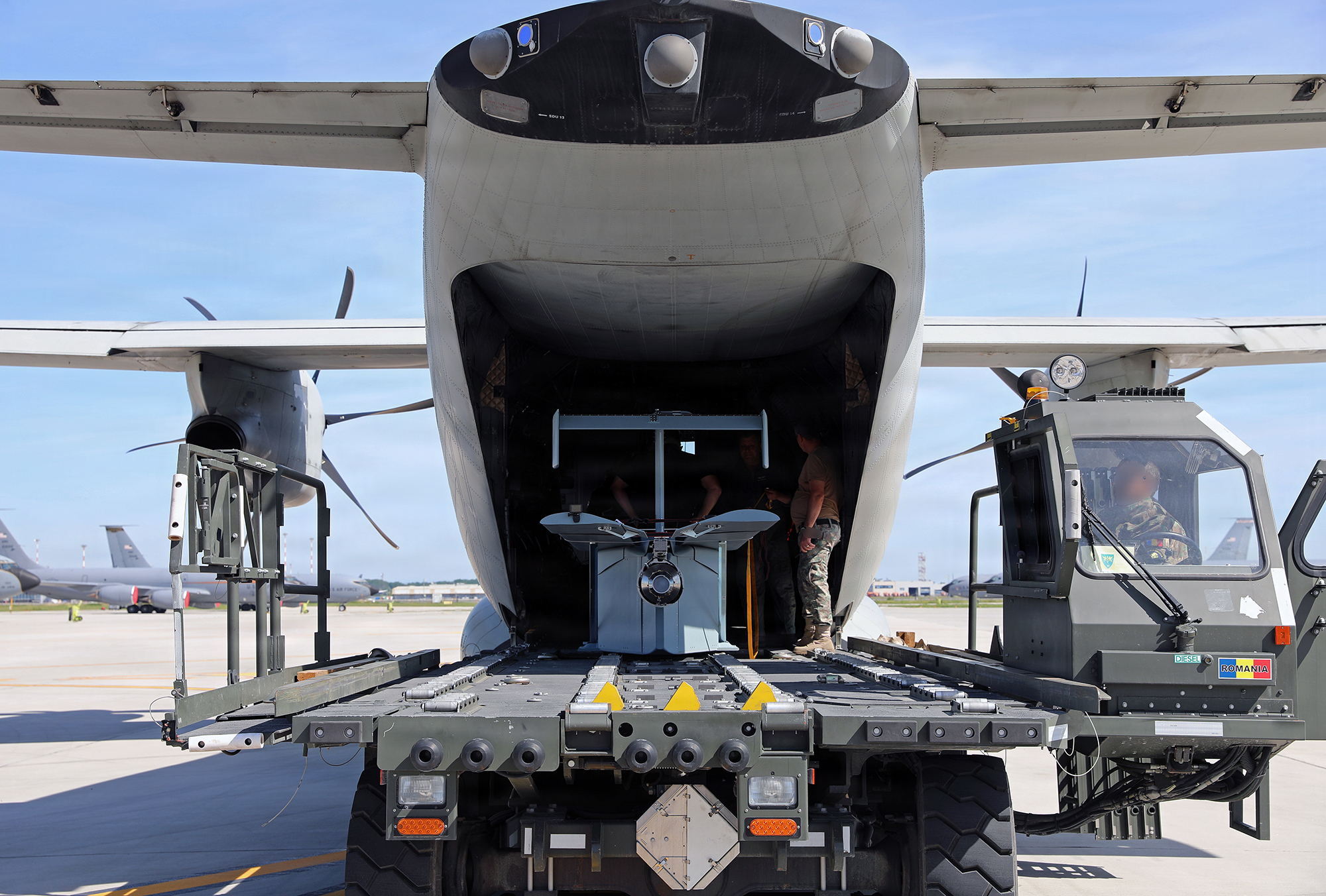 Airmen with the Romanian air force prepare a Long Range Grasshopper system for flight aboard an Alenia C-27J Spartan aircraft during Exercise Trojan Footprint 26 in Bucharest, Romania, May 15, 2026. The operational employment demonstrated evolving precision delivery concepts supporting distributed logistics across the European theater. (U.S. Army National Guard photo by Staff Sgt. Melyssa Vazquez)