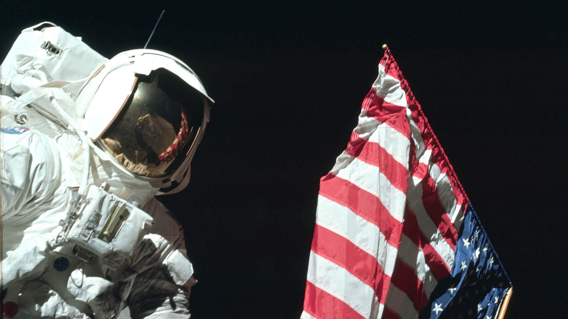 Astronaut Harrison Schmitt poses on the Lunar surface next to an American flag during Apollo 17. (moon surface seen on bottom of image). (Photo by: HUM Images/Universal Images Group via Getty Images)