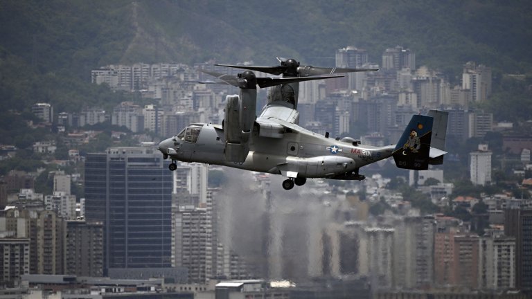 A US Marines MV-22B Osprey aircraft flies over the city on its way to the US Embassy, in Caracas, on May 23, 2026, during an air evacuation drill. (Photo by Federico PARRA / AFP via Getty Images)