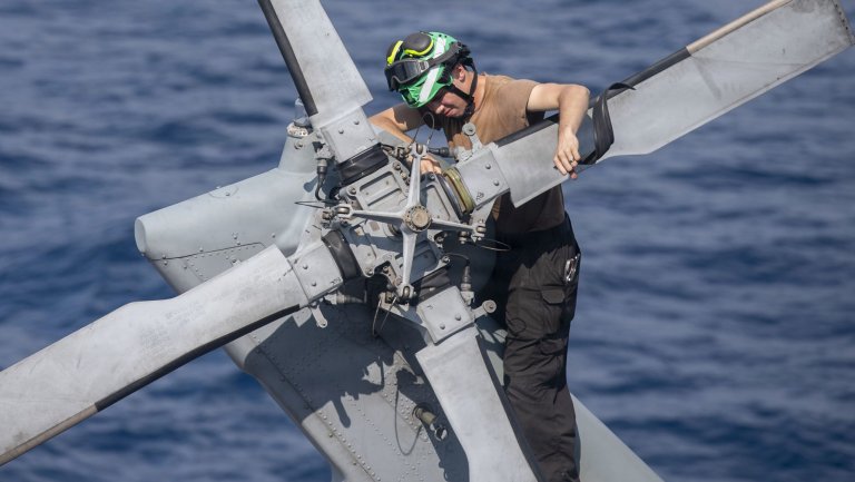 U.S. Navy Aviation Mechanic Airman Andre Gleason, assigned to Helicopter Sea Combat Squadron (HSC) 21, conducts maintenance on an MH-60S Sea Hawk on the flight deck of Wasp-class amphibious assault ship USS Boxer (LHD 4), June 4, 2026. Boxer, flagship of the Boxer Amphibious Ready Group, is underway with the 11th Marine Expeditionary Unit in the U.S.7th Fleet area of operations. U.S. 7th Fleet, the Navy’s largest forward-deployed numbered fleet, routinely interacts and operates with allies and partners to preserve a free and open Indo-Pacific. (U.S. Navy photo by Mass Communication Specialist 3rd Class Martin Perez)