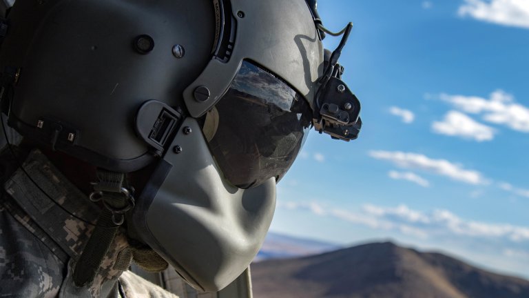 Oregon Army National Guard Sgt. James McKnight, B Co., 1-168th General Support Aviation Battalion, surveys the area out of the side window of the CH-47F Chinook during a dust landing certification flight at the National Training Center (NTC) in Fort Irwin, Calif., May 29, 2019. B Co. 1-168th General Support Aviation Battalion is providing air lift capabilities and support to the 116th Cavalry Brigade Combat Team. A month-long NTC rotation provides more than 4,000 service members from 31 states, including units from 13 National Guard states and territories, with realistic training to enhance their combat, support and sustainment capabilities. (Photo by Cpl. Alisha Grezlik, 115th Mobile Public Affairs Detachment)