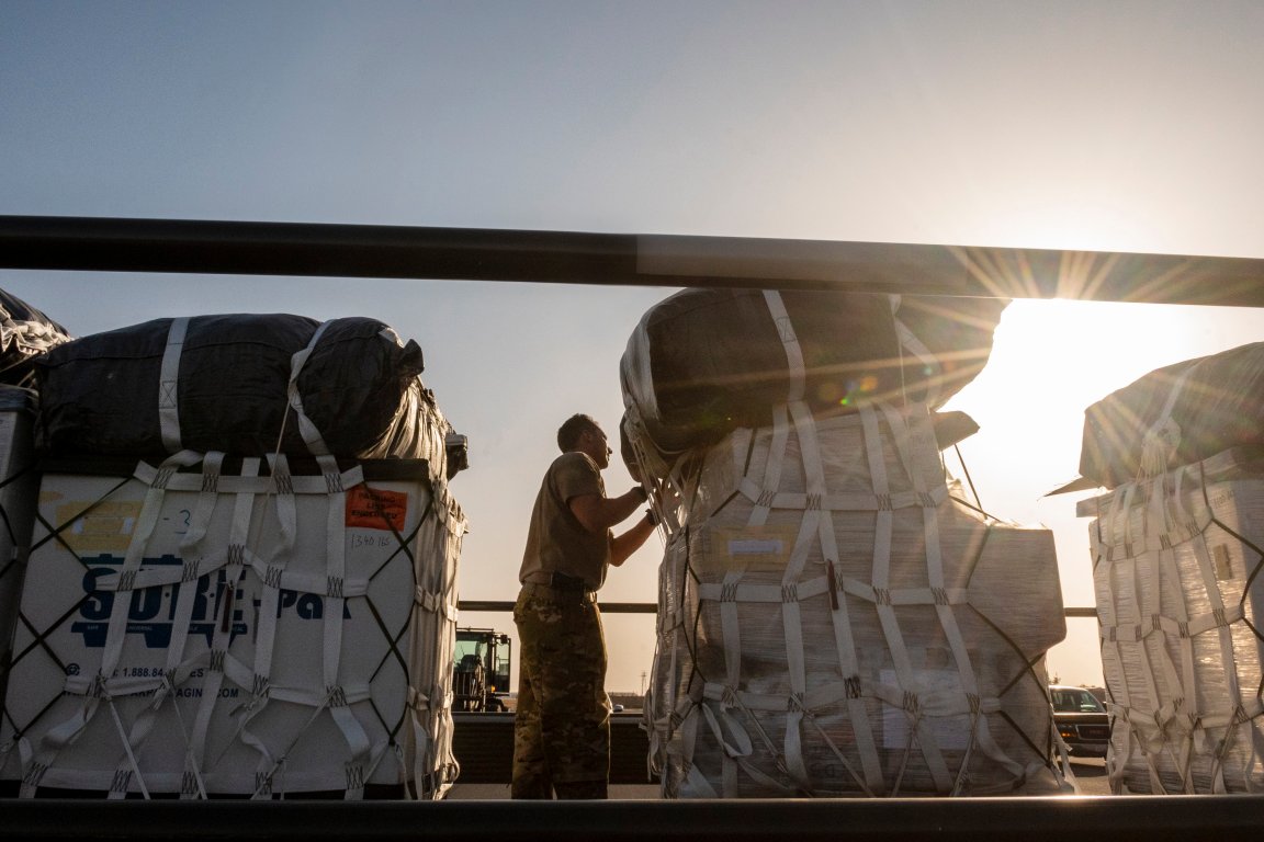 U.S. Air Force Tech. Sgt. Terrance Greenwood, 40th Expeditionary Airlift Squadron C-130 loadmaster, conducts final checks to ensure security of container delivery system bundles before loading onto an aircraft at Ali Al Salem Air Base, Kuwait, July 5, 2023. The 40th EAS provides U.S. Air Forces Central a global reach tactical airlift mission capability and is a prime transport for airdropping and transiting personnel and equipment into hostile areas. (U.S. Air Force photo by Tech. Sgt. Isaac Garden)