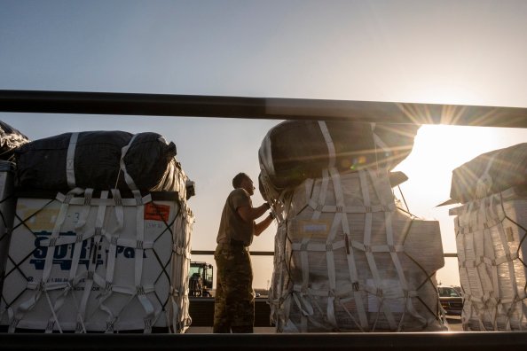 U.S. Air Force Tech. Sgt. Terrance Greenwood, 40th Expeditionary Airlift Squadron C-130 loadmaster, conducts final checks to ensure security of container delivery system bundles before loading onto an aircraft at Ali Al Salem Air Base, Kuwait, July 5, 2023. The 40th EAS provides U.S. Air Forces Central a global reach tactical airlift mission capability and is a prime transport for airdropping and transiting personnel and equipment into hostile areas. (U.S. Air Force photo by Tech. Sgt. Isaac Garden)