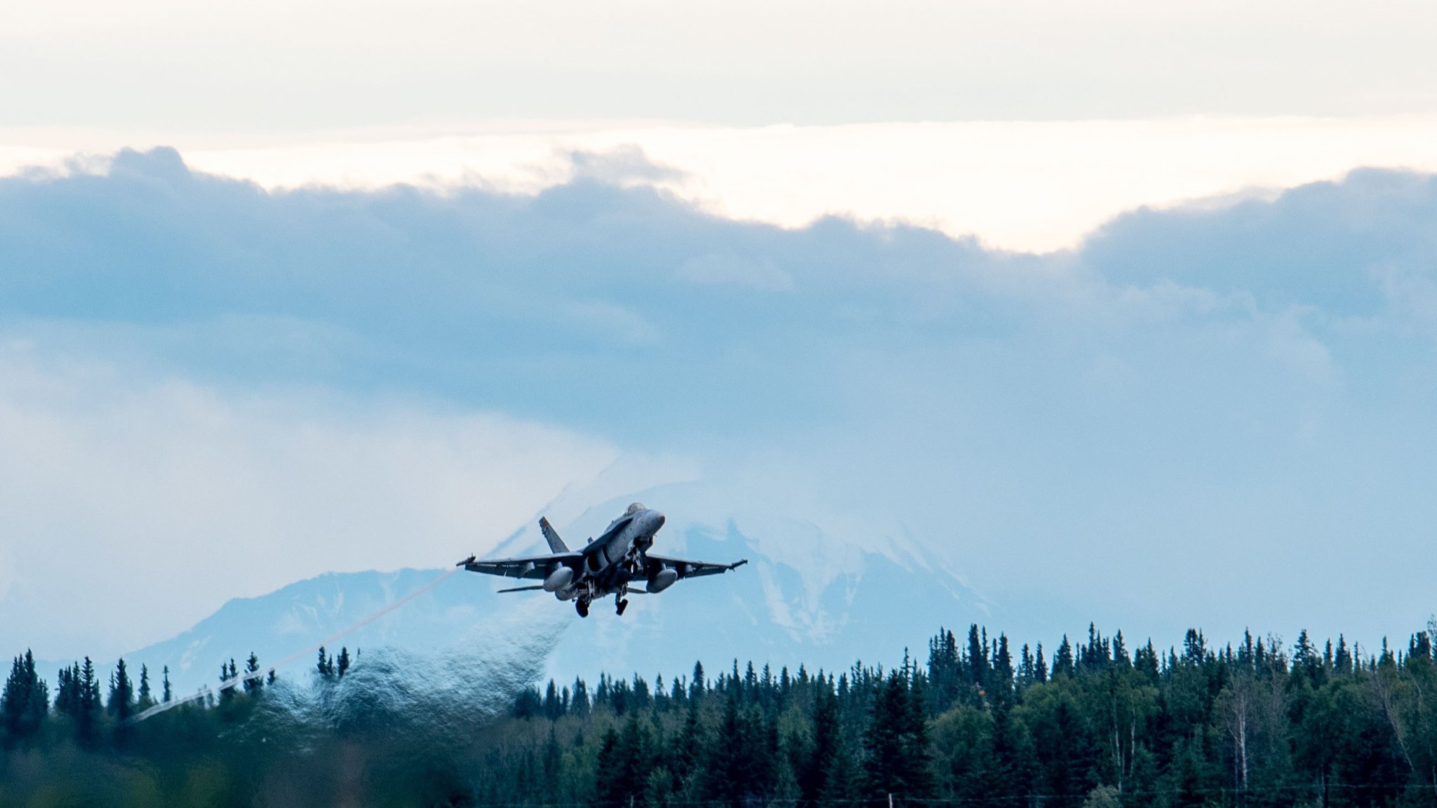 A U.S. Marine Corps F/A-18 Hornet with Marine Fighter Attack Squadron (VMFA) 232 (Reinforced), Marine Aircraft Group 11, 3rd Marine Aircraft Wing, takes off to conduct a simulated suppression of enemy air defenses mission in support of exercise Arctic Defender at Eielson Air Force Base, Alaska, July 9, 2024. The simulated SEAD mission included aircraft from Germany, France, Spain, and the U.S. VMFA-232 (Rein.) is participating with approximately 360 Marines and 19 F/A-18 aircraft in Arctic Defender, a German Air Force-led exercise that provides a unique opportunity to integrate various forces into joint, coalition and multilateral training from simulated forward operating bases. (U.S. Marine Corps photo by Sgt. Luc Boatman) 
