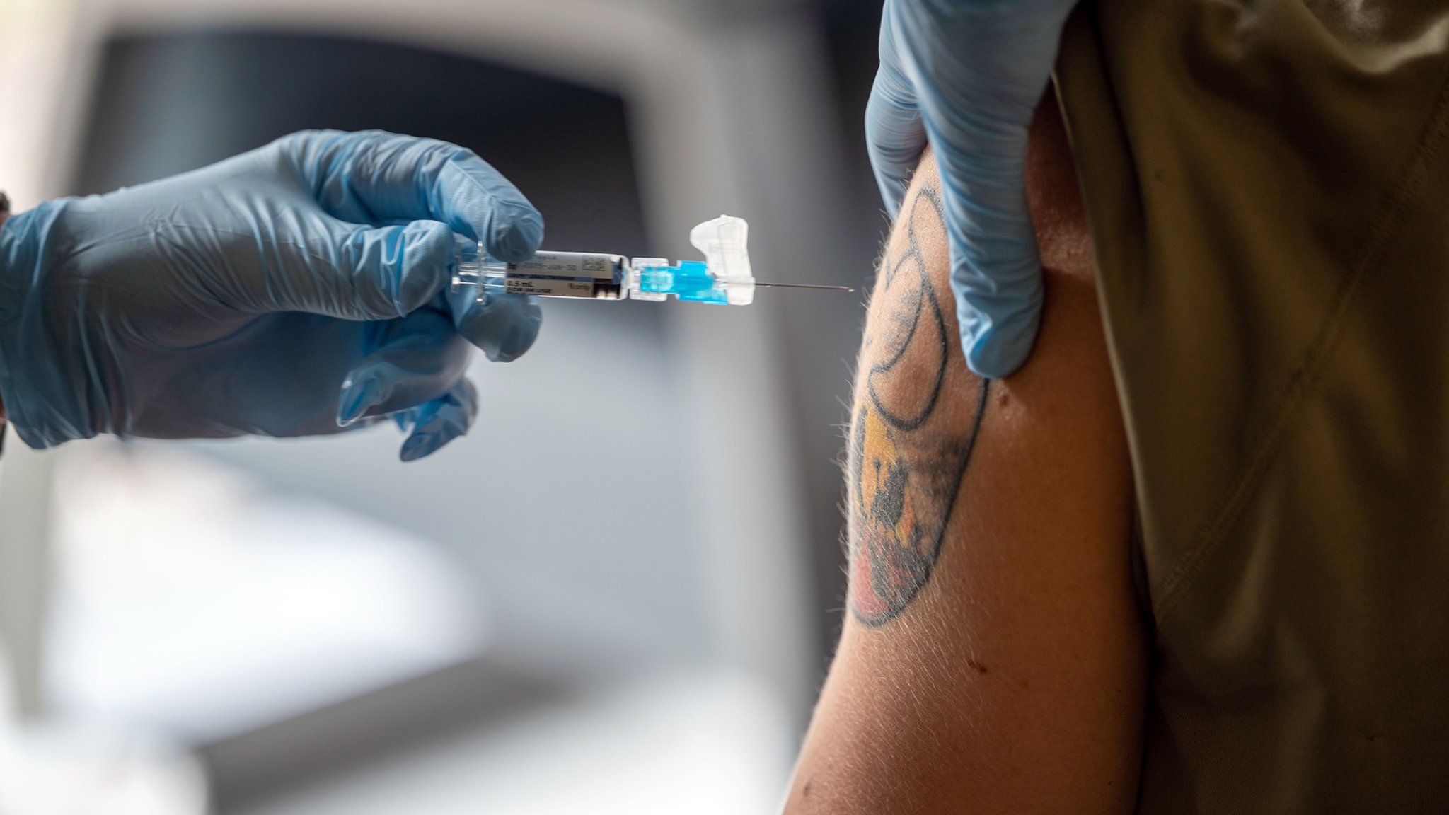 U.S. Air Force Captain Jeslyn Humphrey, 633d Healthcare Operations Squadron clinical nurse, gives Staff Sgt. Nicola Mari, 71st Fighting Generation Squadron tactical aircraft maintainer, a flu shot vaccination at Joint Base Langley-Eustis, Virginia. Nov. 6, 2024. Service members are required to receive vaccinations for the flu to maintain their healthy lifestyles and mission readiness. (U.S. Air Force photo by Airman Donnell Ramsey)