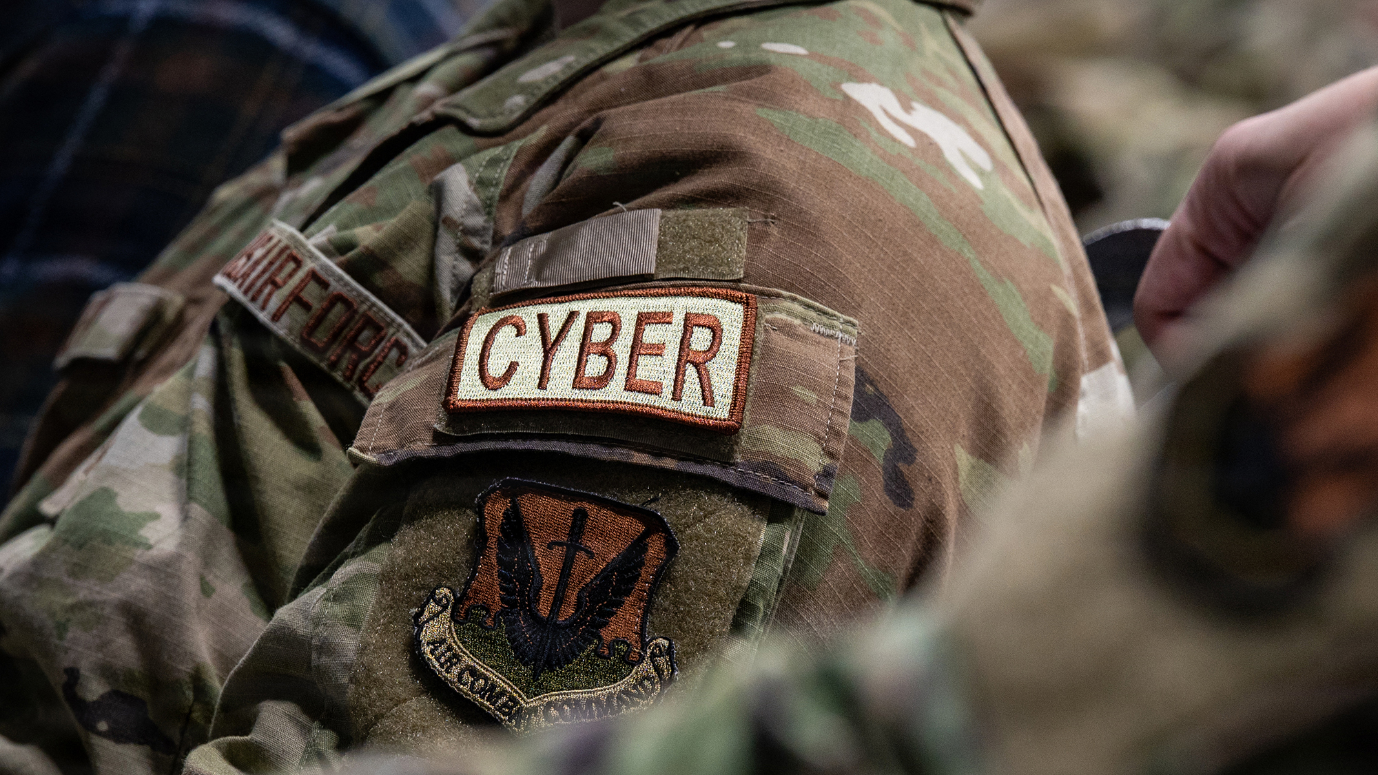 A U.S. Air National Guardsman assigned to the 119th Cyberspace Operations Squadron is seen wearing a cyber operations patch during the unit’s 75th anniversary ceremony at McGhee Tyson Air National Guard Base, Tennessee, Jan. 11, 2026. The ceremony commemorated the squadron’s evolution from air control and warning missions to today’s cyberspace operations role. (U.S. Air National Guard photo by Staff Sgt. Jesse Hanson)
