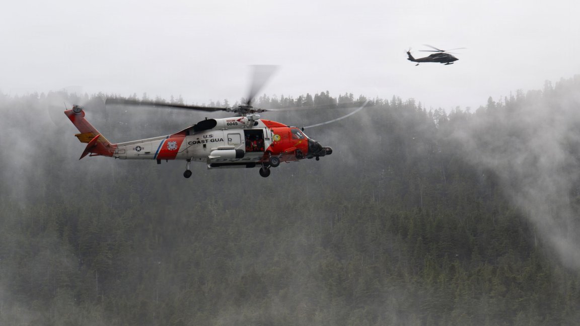 Image: A U.S. Coast Guard MH-60 Jayhawk helicopter crew with Air Station Sitka and A U.S. Army National Guard UH-60L Black Hawk helicopter crew from Juneau, Alaska, fly near each other during a mass casualty exercise near Sitka, Alaska, April 16, 2026. The helicopter crews rescued a large number of training participants that simulated distress in difficult to navigate areas during a large joint exercise involving multiple government agencies and local organizations. (U.S. Coast Guard photo by Petty Officer 2nd Class John Hightower) 