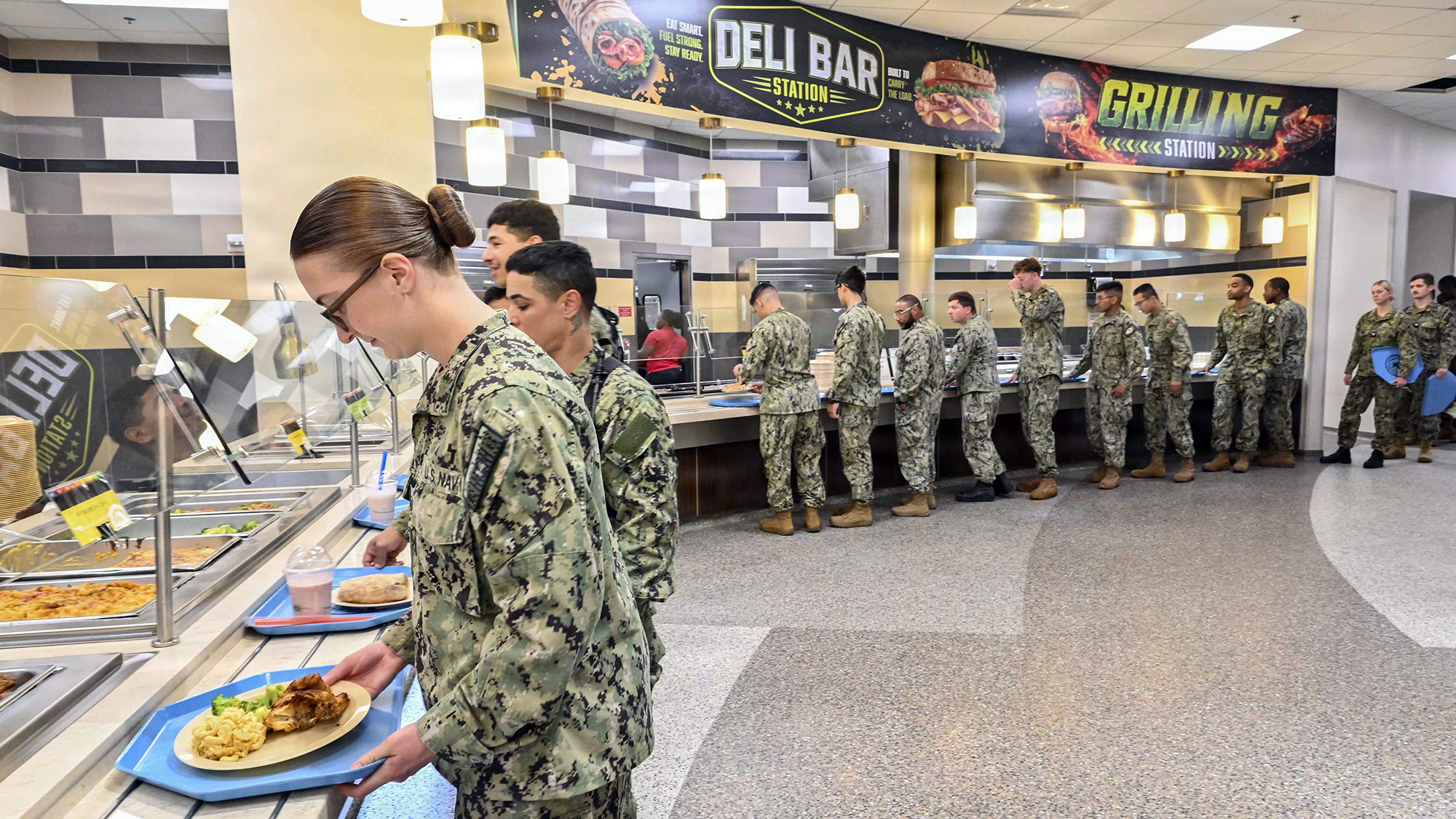 260529-N-YM856-1452 GULFPORT, MS (May 29, 2026) Sailors try new menu options during the reopening of Colmer Dining Facility following the facility’s food service transformation, May 29. The “campus style” dining pilot program is part of the Navy’s shore food service transformation initiative to provide an improved galley experience to support warfighter readiness, wellness, and performance through better nutrition. (U.S. Navy Photo by Mass Communication Specialist 1st Class Brittney Kinsey)