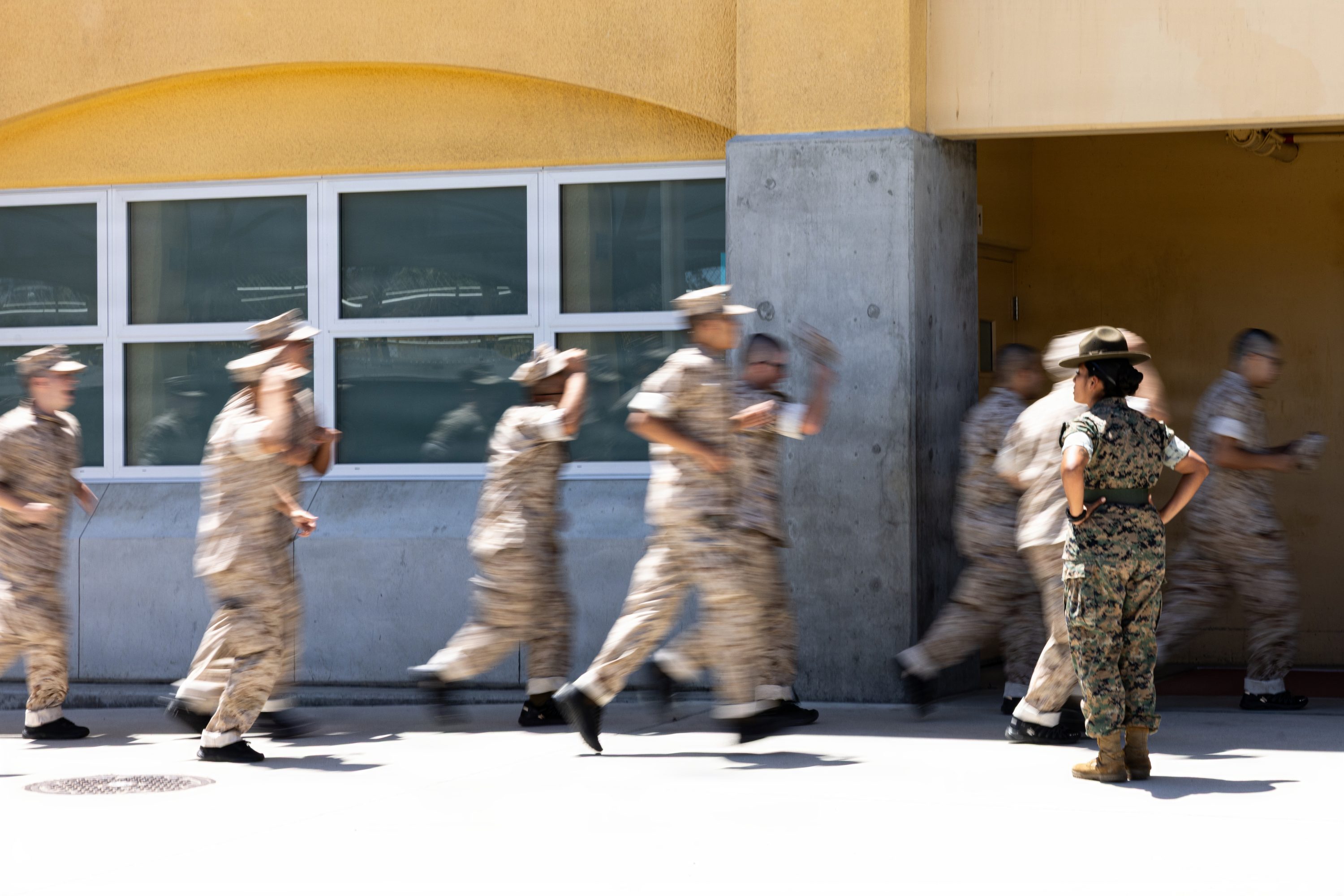 U.S. Marine Corps recruits with Mike Company, 3rd Recruit Training Battalion run to their squad-bay during Pick-Up Day at Marine Corps Recruit Depot San Diego, California, May 30, 2026. Pick-Up Day signifies the first official day of training in which recruits will meet their drill instructor team for the first time, prepare their gear and squad bays, and expectations are set for the remainder of their time in recruit training. (U.S. Marine Corps photo by Cpl. Evelyn Doherty)