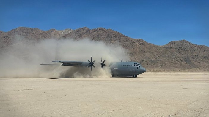 C-130J Hercules aircraft from 143d Airlift Wing, Rhode Island Air National Guard lands at the National Training Center at Fort Irwin, California on June 10, 2026. The movement was part of Alpha Battery, 1st Battalion, 182nd Field Artillery Regiment, Michigan Army National Guard Minuteman Rotation at the National Training Center at Fort Irwin, California to conduct a HIMARS Rapid Infiltration (HIRAIN) exercise. The HIRAIN demonstrated the unit's capability to rapidly deploy a HIMARS via airlift, execute a strike, and exfiltrate to avoid detection. (U.S. Army National Guard photo by 1st Lt. Daniel Throne)