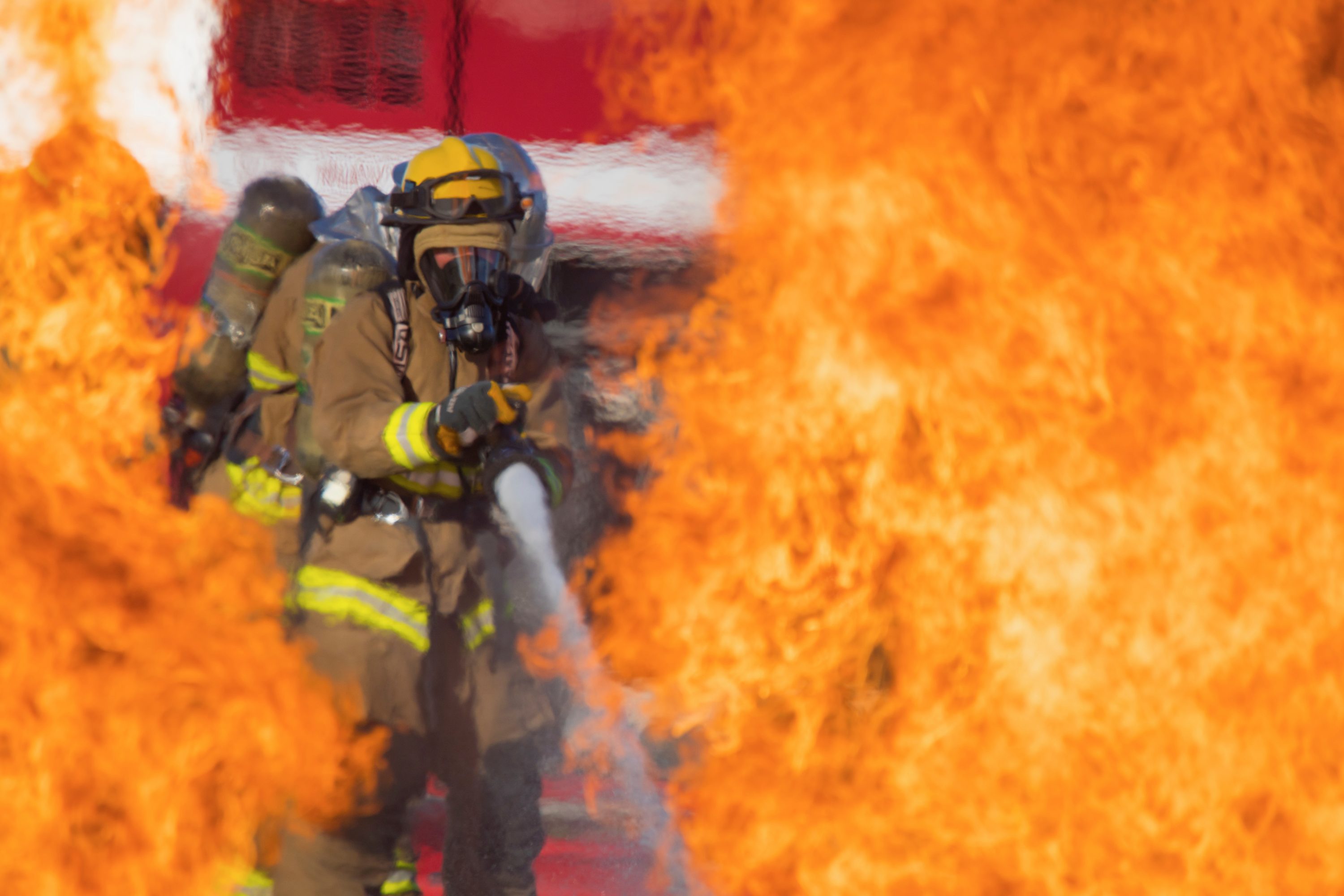 U.S. Marine Corps Lance Cpl. Cole McEachern, a fire fighter technician with Marine Wing Support Squadron 171, extinguishes a fire during a controlled burn exercise at Andersen Air Force Base, Guam, July 28, 2021. Marines, Airmen, and Guam International Airport Fire Department crash fire rescue take part in annual training exercises in order to remain proficient in firefighting and rescue procedures to ensure safe airfield operations. (U.S. Marine Corps photo by Lance Cpl. Tyler Harmon)