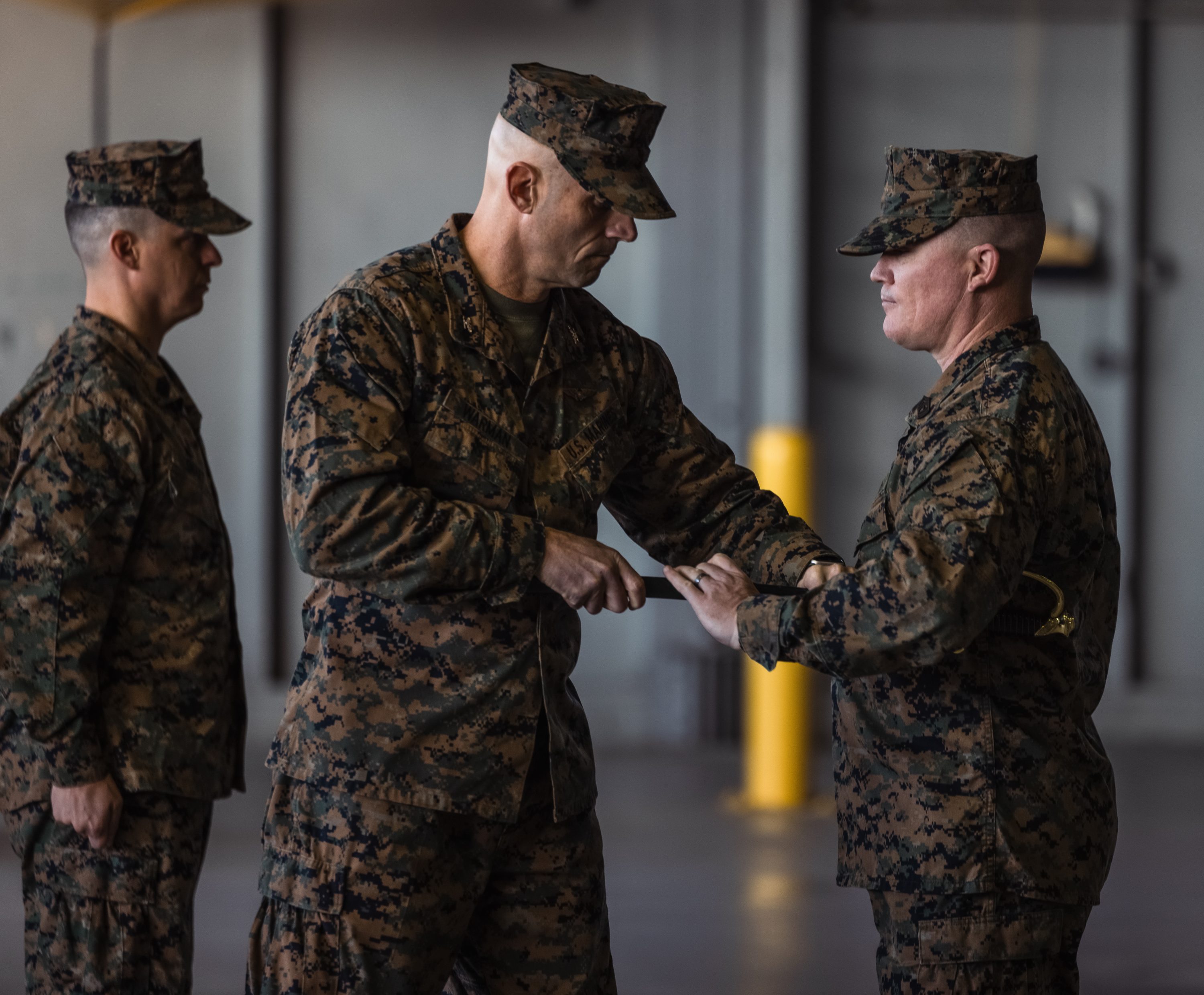 U.S. Marine Corps Col. Scott Warman, left, commanding officer of Marine Corps Air Facility Quantico, gives the non-commissioned officer sword to 1st Sgt. Christopher Rushton, incoming senior enlisted leader of MCAF, during a relief and appointment ceremony at MCAF on Marine Corps Base Quantico, Virginia, Dec. 3, 2024. 1st Sgt. Brandon Smart transferred authority to Rushton after serving as the senior enlisted leader for over a year. (U.S. Marine Corps photo by Lance Cpl. Ethan Miller)