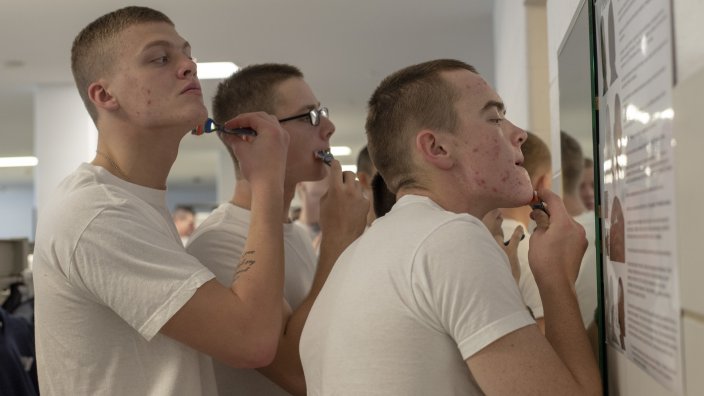 181031-N-PL946-1051 GREAT LAKES, Ill. (Oct. 31, 2018) Recruits touch up their shave in preparation for an inspection inside their compartment in the USS Arleigh Burke barracks at Recruit Training Command. More than 30,000 recruits graduate annually from the Navy's only boot camp. (U.S. Navy photo by Mass Communication Specialist 2nd Class Spencer Fling)