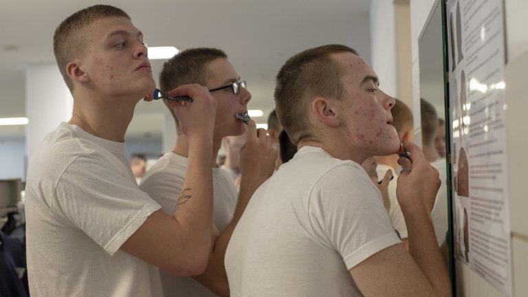 181031-N-PL946-1051 GREAT LAKES, Ill. (Oct. 31, 2018) Recruits touch up their shave in preparation for an inspection inside their compartment in the USS Arleigh Burke barracks at Recruit Training Command. More than 30,000 recruits graduate annually from the Navy's only boot camp. (U.S. Navy photo by Mass Communication Specialist 2nd Class Spencer Fling)