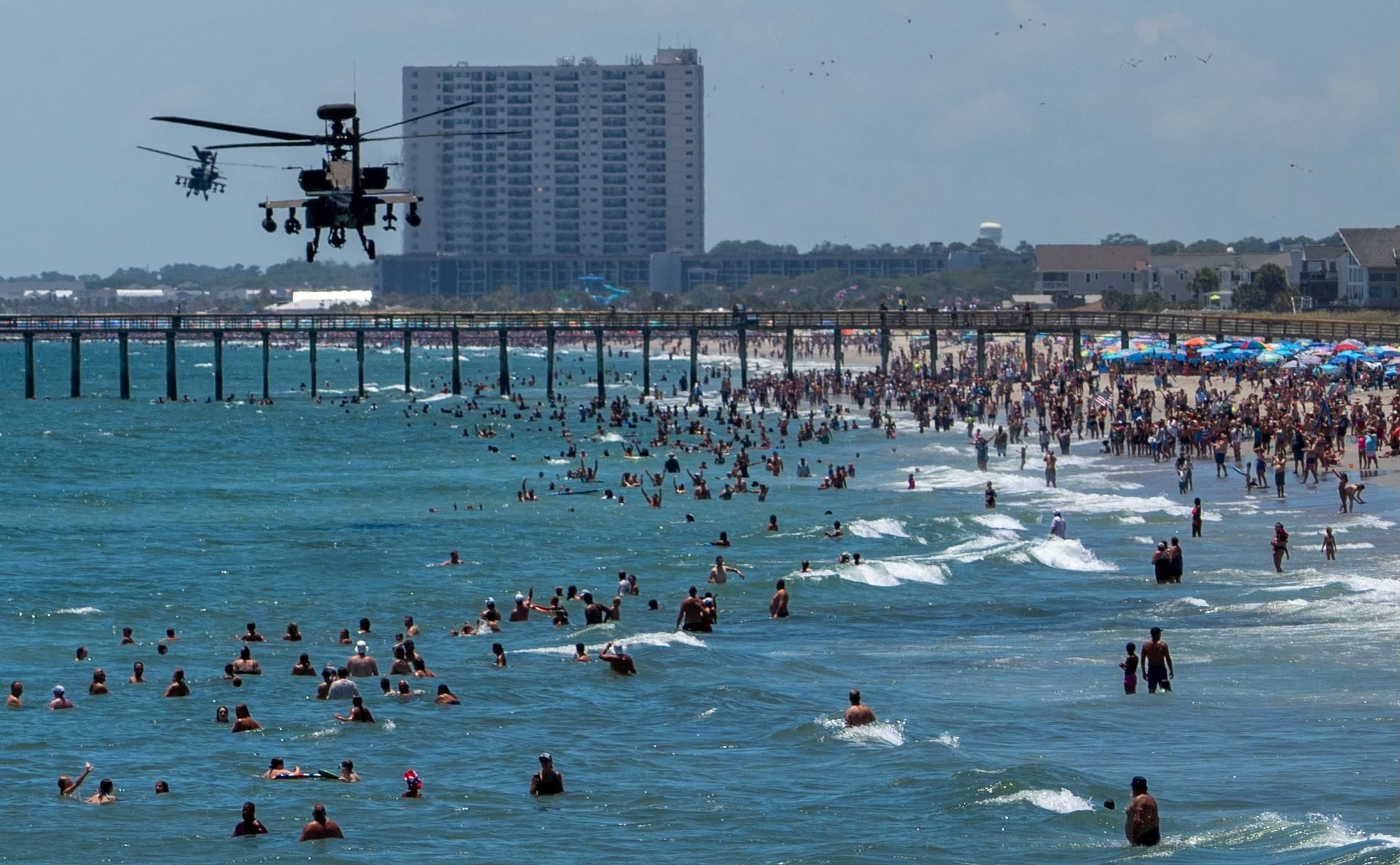 Two AH-64E Apache helicopters fly plast Myrtle Beach, South Carolina on July 4, 2026.