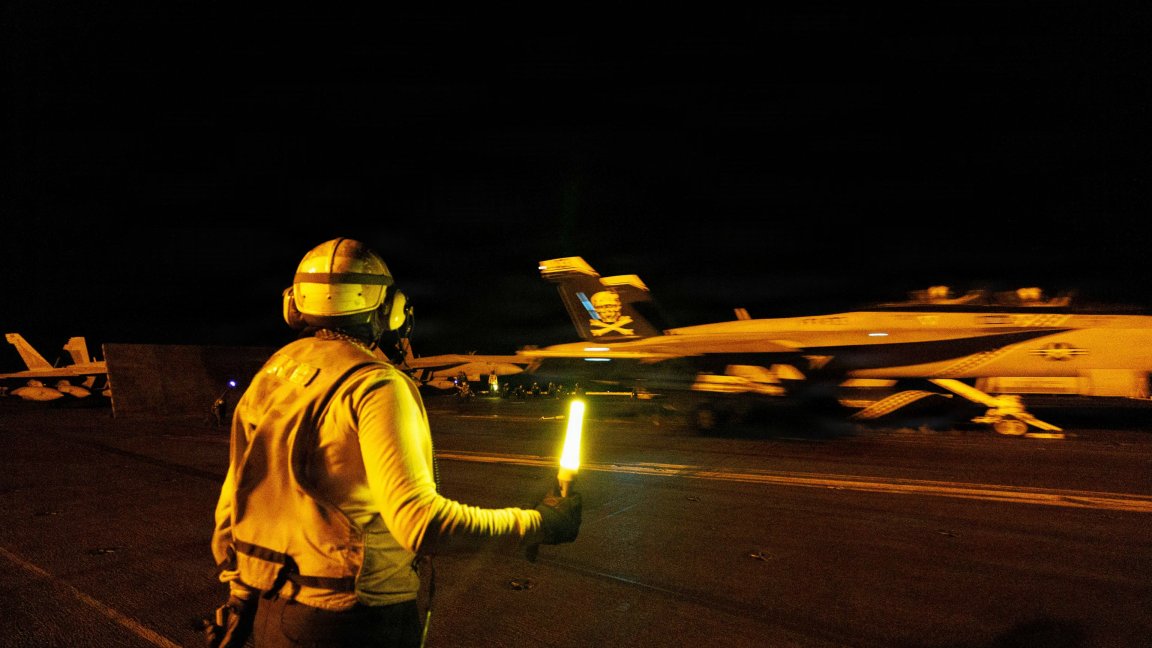 A U.S. Sailor signals an F/A-18E Super Hornet, attached to Strike Fighter Squadron (VFA) 103, on the flight deck of Nimitz-class aircraft carrier USS George H.W. Bush (CVN 77) while sailing in the Arabian Sea, June 23, 2026. USS George H.W. Bush is deployed to the U.S. 5th Fleet area of operations to support maritime security and stability in the Middle East. (U.S. Navy photo) 