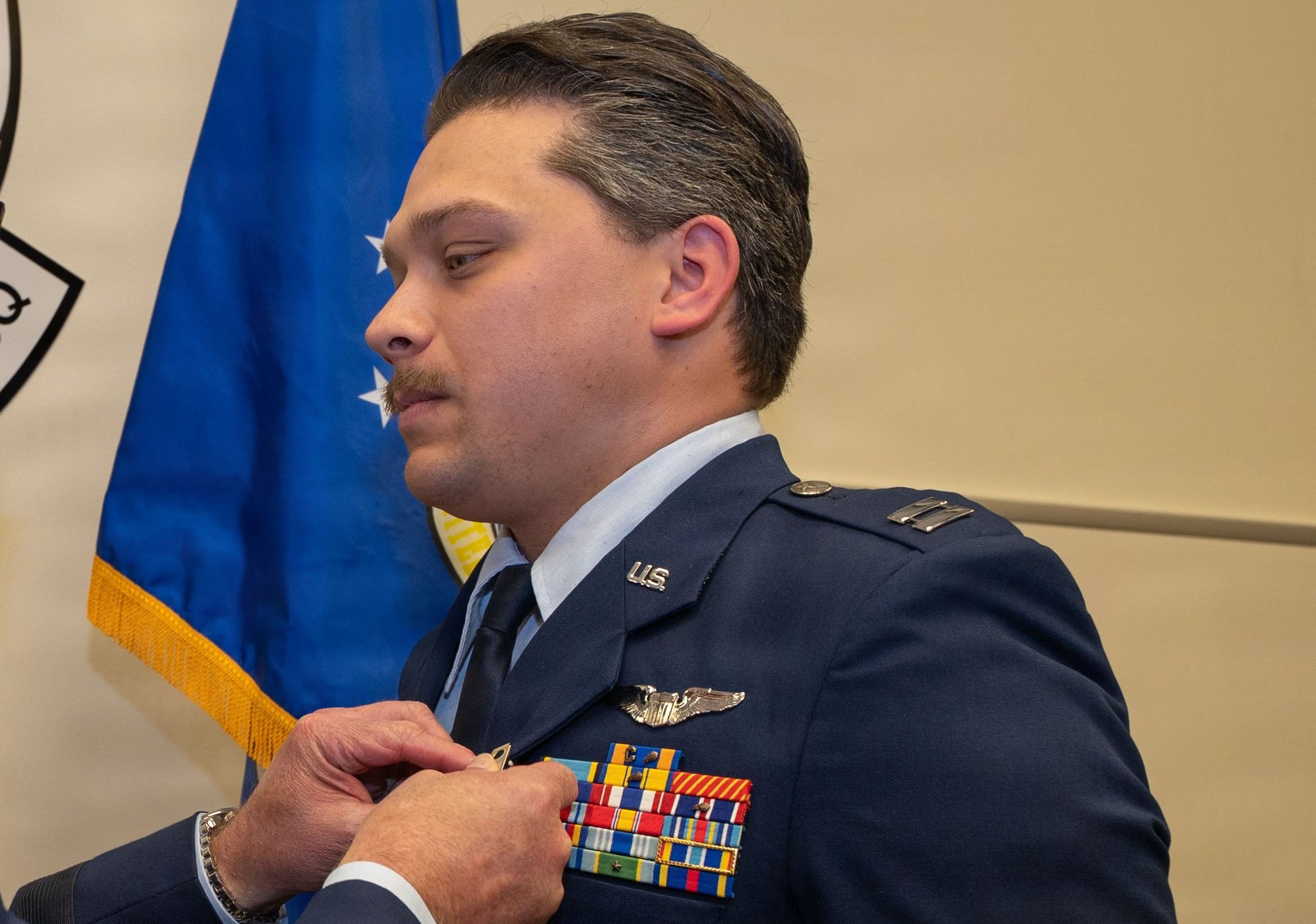 U.S. Air Force U.S. Air Force Lt. Gen. Robert Davis, commander, Alaskan North American Aerospace Defense Command Region, Alaskan Command ,and Eleventh Air Force, pins the Distinguished Flying Cross on Capt. Nathanial Welch, 18th Fighter Interceptor Squadron pilot and chief of plans and programs, during a ceremony at Eielson Air Force Base, Alaska, July 1, 2026. Welch received the decoration for his heroism and bravery he exemplified while evading enemy missiles flying as an F-16 Fighting Falcon pilot with the 480th Expeditionary Fighter Squadron at Prince Sultan Air Base, Kingdom of Saudi Arabia, evading enemy missiles through exceptional flying and protecting coalition aircraft until they were safely clear of the threat. (U.S. Air Force Photo by Airman 1st Class Mary Murray) 