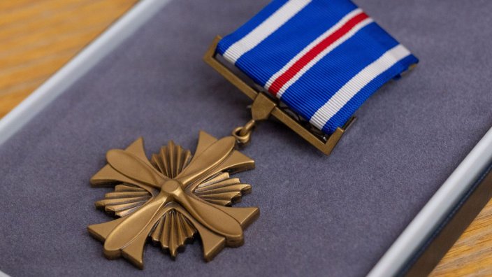 A Distinguished Flying Cross medal is displayed for presentation during a ceremony at Eielson Air Force Base, Alaska, July 1, 2026. The Distinguished Flying Cross recognizes heroism or extraordinary achievement while participating in an aerial flight and honors those whose actions go beyond the demands of duty during combat or active operations against an armed adversary. (U.S. Air Force Photo by Airman 1st Class Mary Murray)