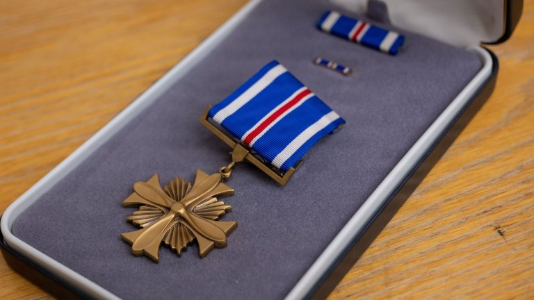 A Distinguished Flying Cross medal is displayed for presentation during a ceremony at Eielson Air Force Base, Alaska, July 1, 2026. The Distinguished Flying Cross recognizes heroism or extraordinary achievement while participating in an aerial flight and honors those whose actions go beyond the demands of duty during combat or active operations against an armed adversary. (U.S. Air Force Photo by Airman 1st Class Mary Murray)