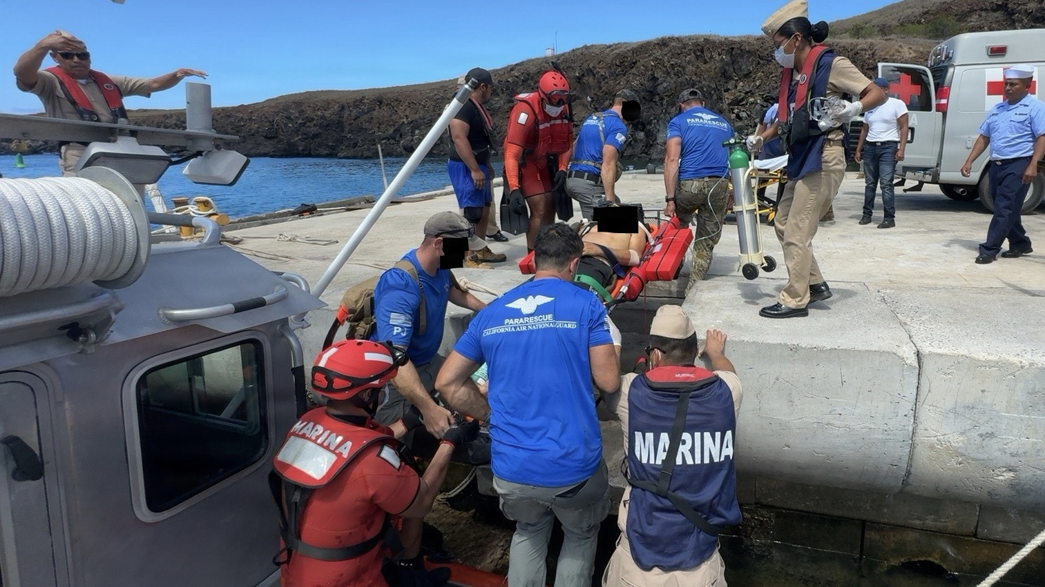 Pararescuemen from the 129th Rescue Wing's 131st Rescue Squadron, transfer a patient onto land at Socorro Island, July 7, 2026. The patient was treated at sea until he could receive higher medical care. (Courtesy Photo)