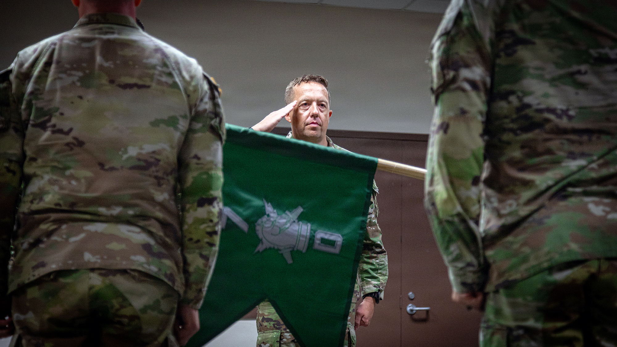 U.S. Army 1st Sgt. Joshua T. Libro, incoming company first sergeant, Drongo Company, 7th Psychological Operations Battalion (Special Operations) (Airborne), 3rd Special Forces Group (Airborne), salutes the company guidon before the longstanding Army tradition of the passing of the colors during a company activation ceremony on Fort Bragg, North Carolina, July 15, 2026. The activation of Drongo Company marks a milestone among Army Special Operations Forces to meet the growing demands of the United States Army. The newly activated company provides operational flexibility for commanders to execute a wide array of Special Operators Forces core activities throughout the world while maintaining a high degree of operational readiness. (U.S. Army Photo by Spc. Seu Chan)