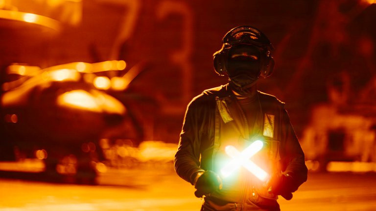 A U.S. Sailor poses for a photo on the flight deck of Nimitz-class aircraft carrier USS George Washington (CVN 73), Aug. 25, 2026. George Washington is deployed to the U.S. 5th Fleet area of operations to support maritime security and stability in the Middle East. (U.S. Navy photo)