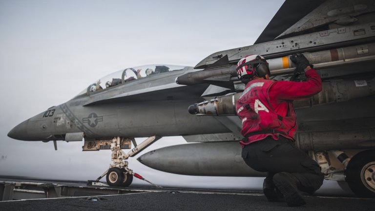 A U.S. Sailor checks ordnance on an F/A-18 Super Hornet, attached to Strike Fighter Squadron (VFA) 102, aboard Nimitz-class aircraft carrier USS George Washington (CVN 73), Sept. 13, 2026. George Washington is deployed to the U.S. 5th Fleet area of operations to support maritime security and stability in the Middle East. (U.S. Navy photo)