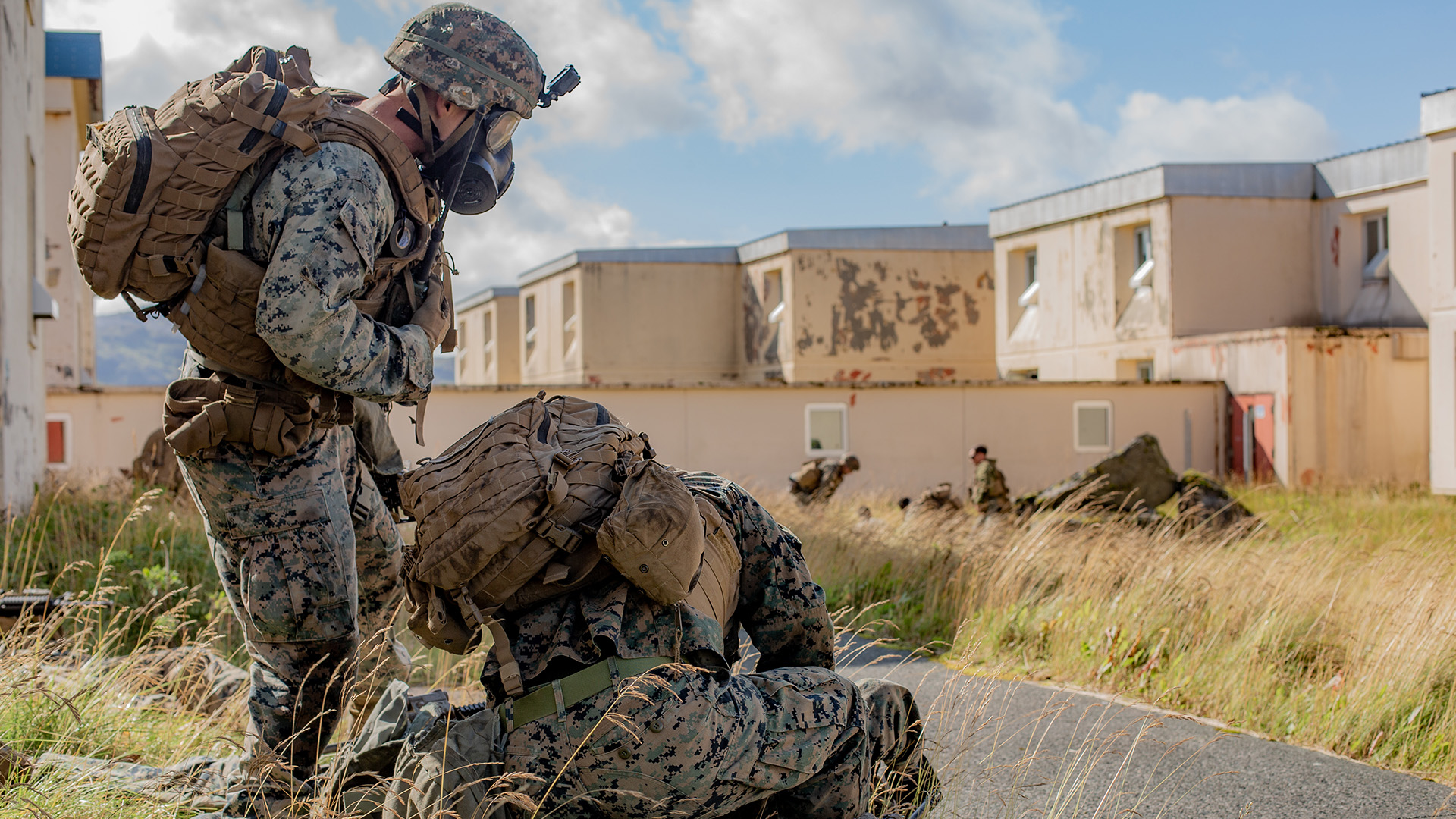 While "raiding" abandoned buildings on the former Navy base in Adak, Alaska, Marines treat a simulated casaulty during Arctic Expeditionary Capabilities Exercise in 2019.