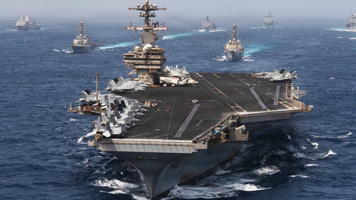 Navy warships including an aircraft carrier sail through the Arabian Sea on June 30, 2026.