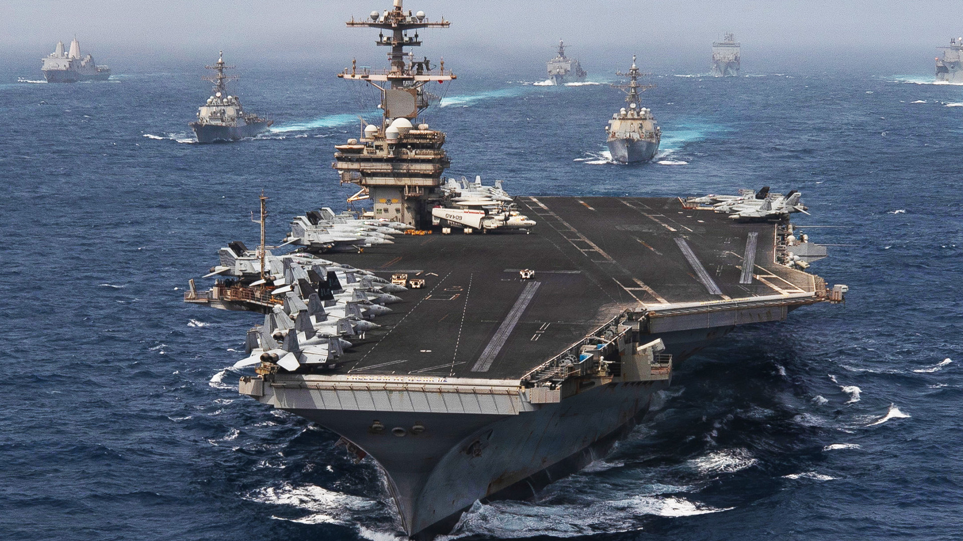 Navy warships including an aircraft carrier sail through the Arabian Sea on June 30, 2026.