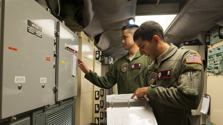 Second Lt. Nikolas Ramos, 320th Missile Squadron deputy missile combat crew commander, reads a checklist while 1st Lt. Terrence Dale Duarte, missile combat crew commander complies with the instructions in a launch control center at F.E. Warren Air Force Base, Wyo., Nov. 5, 2016. The 90th Missile Wing sustains 150 Minuteman III ICBMs and the associated launch facilities that cover 9,600 square miles across three states. (U.S. Air Force photo by Staff Sgt. Christopher Ruano) 