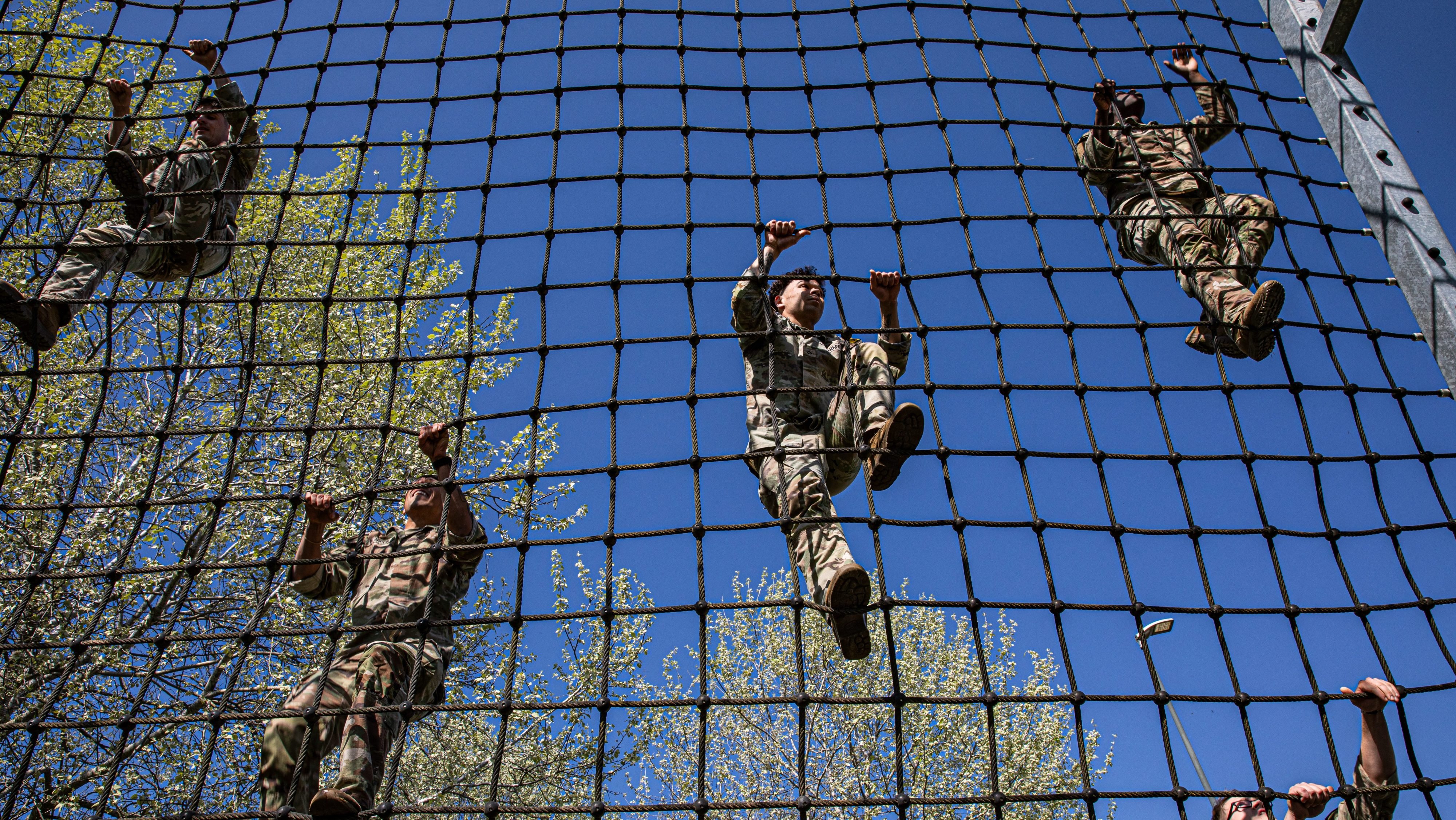 U.S. Soldiers assigned to 4th Battalion, 319th Field Artillery Regiment, 173rd Airborne Brigade, climb an obstacle during U.S. Army Southern European Task Force, Africa (SETAF-AF) Best Squad Competition (BSC) at Caserma Del Din, Italy, April 8, 2025. The three-day SETAF-AF BSC assesses each squad on their technical and tactical proficiency, as well as their ability to work as a disciplined and cohesive team. The top squads will represent SETAF-AF in the U.S. Army Europe and Africa BSC. (U.S. Army photo by Sgt. Christopher Sanchez)