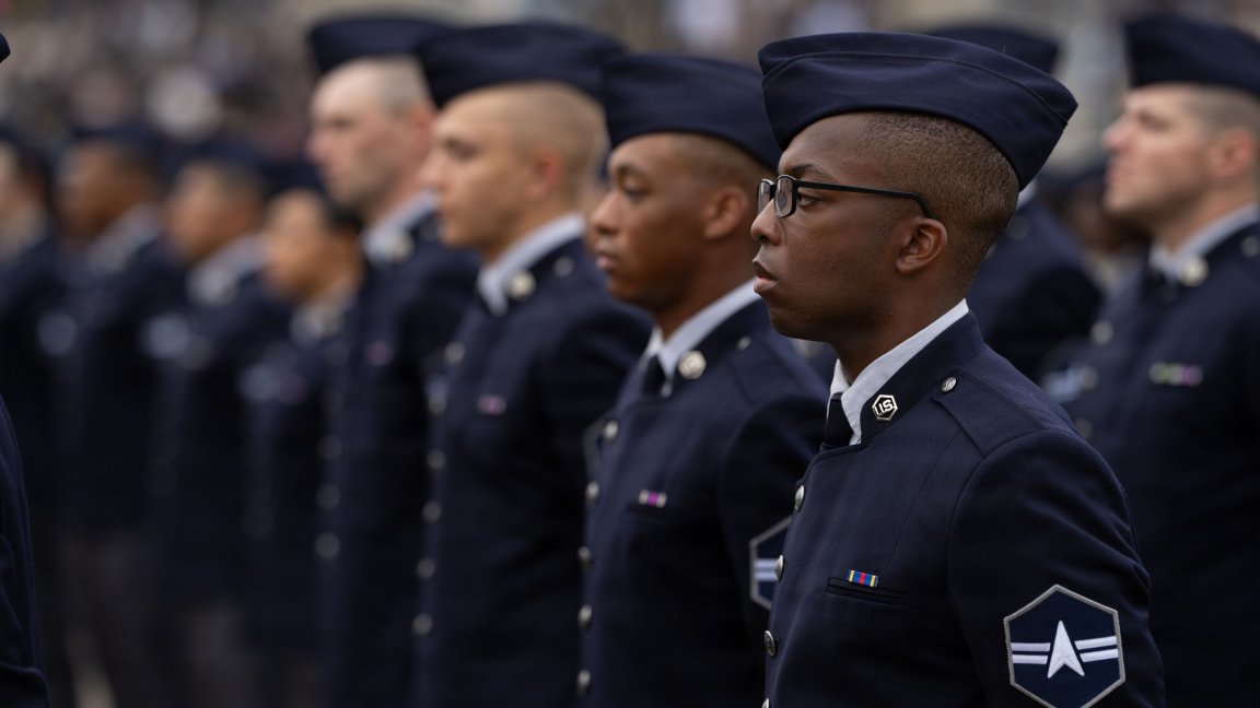 Guardians from Flights 057-063 stand at parade rest during a graduation ceremony at Joint Base San Antonio-Lackland, Texas, Dec. 18, 2025. The event, hosted by the 737th Training Group, marks the completion of Department of the Air Force Basic Military Training. Guardians wore the new Space Force service dress uniform for the first time at a BMT graduation, representing the service’s evolving identity and shared training foundation with the U.S. Air Force.