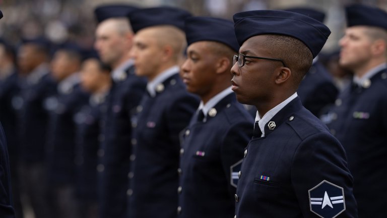 Guardians from Flights 057-063 stand at parade rest during a graduation ceremony at Joint Base San Antonio-Lackland, Texas, Dec. 18, 2025. The event, hosted by the 737th Training Group, marks the completion of Department of the Air Force Basic Military Training. Guardians wore the new Space Force service dress uniform for the first time at a BMT graduation, representing the service’s evolving identity and shared training foundation with the U.S. Air Force.
