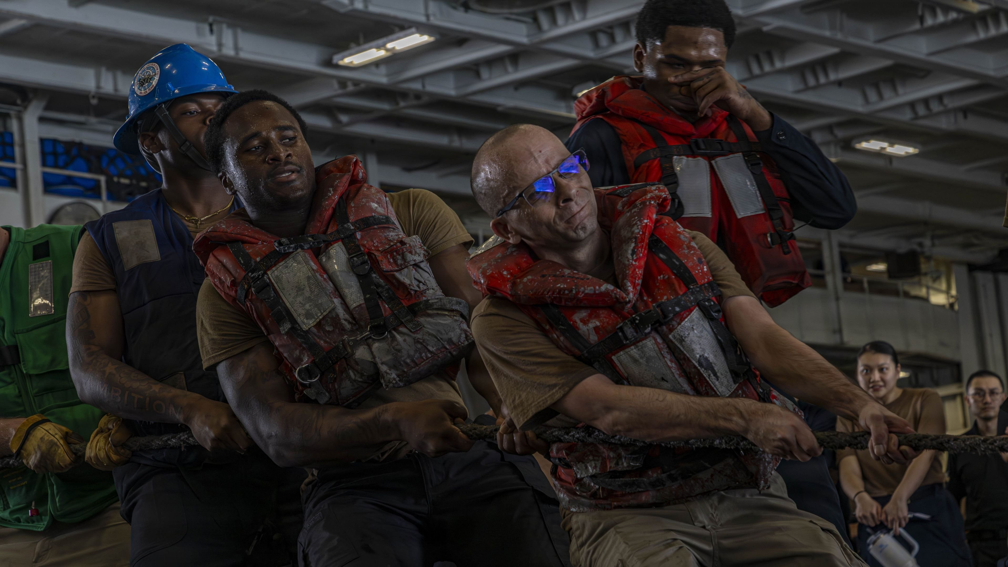 U.S. Sailors heave a line during a replenishment-at-sea with Lewis and Clark-class dry cargo and ammunition ship USNS Cesar Chavez (T-AKE-14) and Nimitz-class aircraft carrier USS Abraham Lincoln (CVN 72), July 4, 2026. Abraham Lincoln is deployed to the U.S. 5th Fleet area of operations to support maritime security and stability in the Middle East. (U.S. Navy photo)