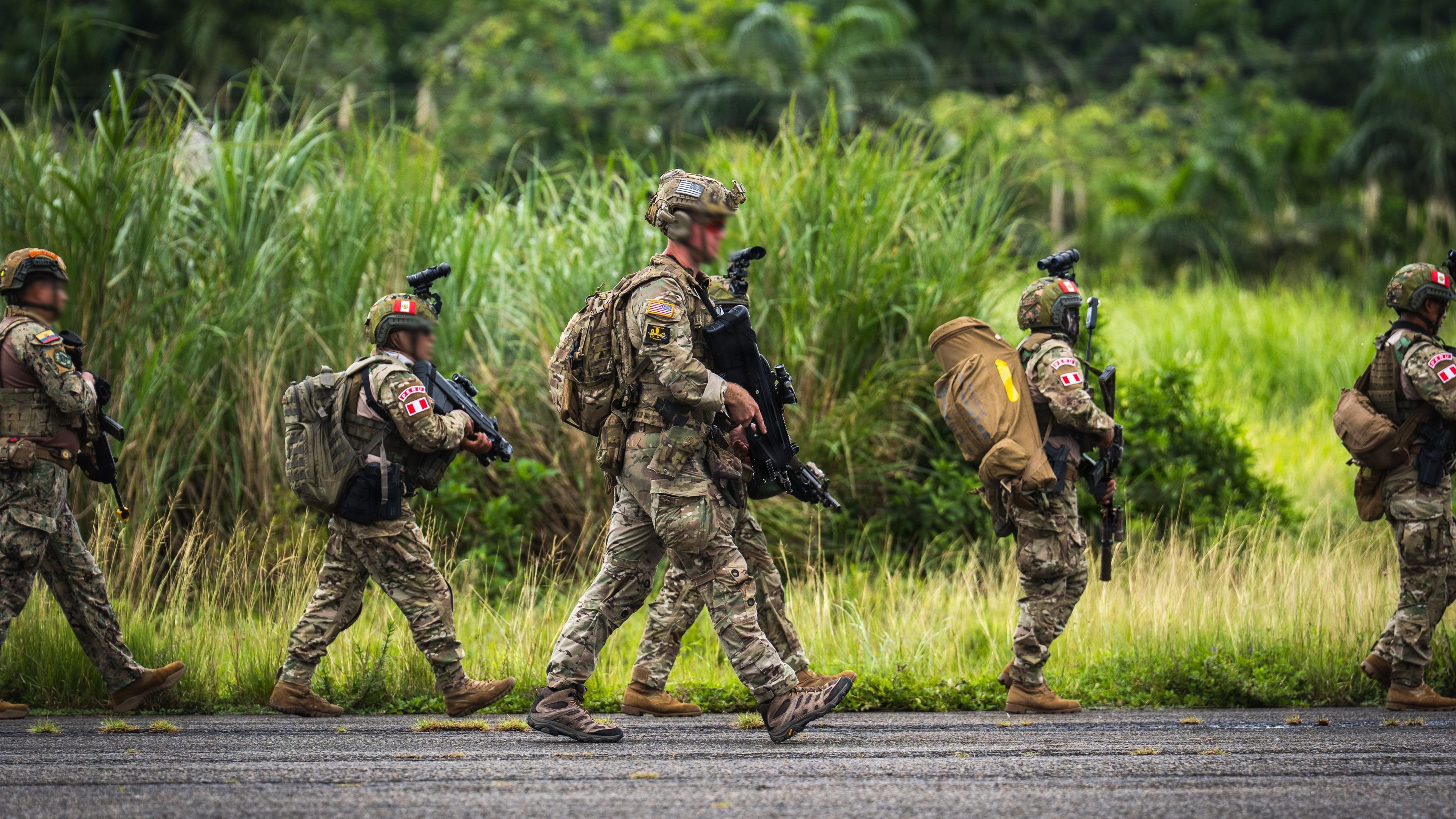 A U.S. Army Special Forces soldier moves with members of Peru's Comando de Inteligencia y Operaciones Especiales Conjuntas (CIOEC) and the Ecuadorian Marine Corps' Grupo de Acción Rápida de la Infantería de Marina (GAHRIM) toward a rally point during PANAMAX 2026 in Colón Province, Panama, Aug. 6, 2026. PANAMAX 2026 scenarios help the defense and public security forces of participating nations improve interoperability, hone their skills during scenarios involving coalition and all-domain operations, forge strong cooperative partnerships, and demonstrate their collective capacity to respond to and deter threats to the region and its critical waterways. (U.S. Army photo by Maj. Trevor Wild)