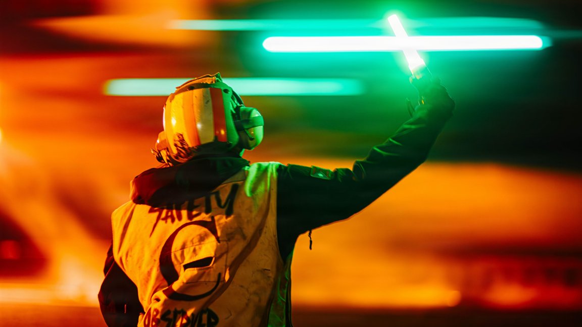 A U.S. Sailor signals an F/A-18 Super Hornet assigned to Strike Fighter Squadron (VFA) 195, during a launch from the flight deck of Nimitz-class aircraft carrier USS George Washington (CVN 73), Aug. 28, 2026. George Washington is deployed to the U.S. 5th Fleet area of operations to support maritime security and stability in the Middle East. (U.S. Navy photo)