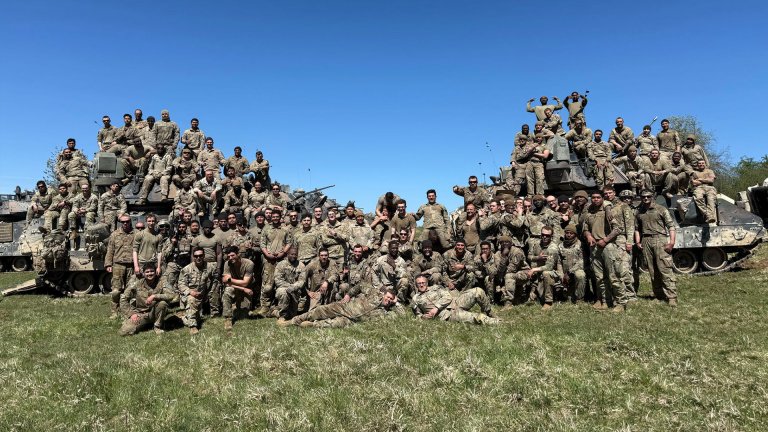 Soldiers of Blackhawk Company, 2nd Battalion, 7th Cavalry Regiment, pile on top of two Bradley fighting vehicles after the 10-day Combined Resolve exercise, in which they took on elite Ukranian drone units.