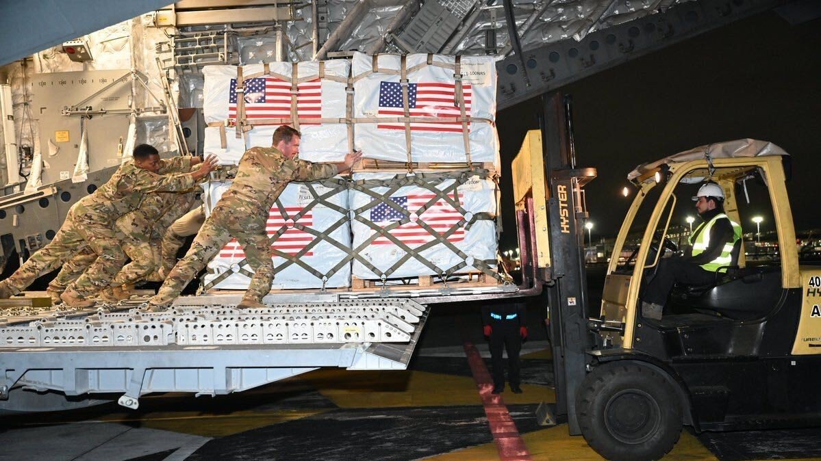 American troops move cargo pallets of supplies on a C-17 Globemaster, ordered to ferry supplies to Colombia.
