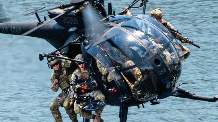 U.S. Special Operations Forces members fly over Tampa Bay in a U.S. Army MH-6 helicopter during a SOF capabilities demonstration May 18, 2022 in Tampa, Florida. SOF Week is the premier gathering for the SOF community and industry, bringing together more than 11,000 attendees, including representatives from more than 100 countries to collaborate on new initiatives and capabilities needed for SOF professionals to compete and win in the future. (U.S. Air Force photo by Staff Sgt. Alexander Cook)