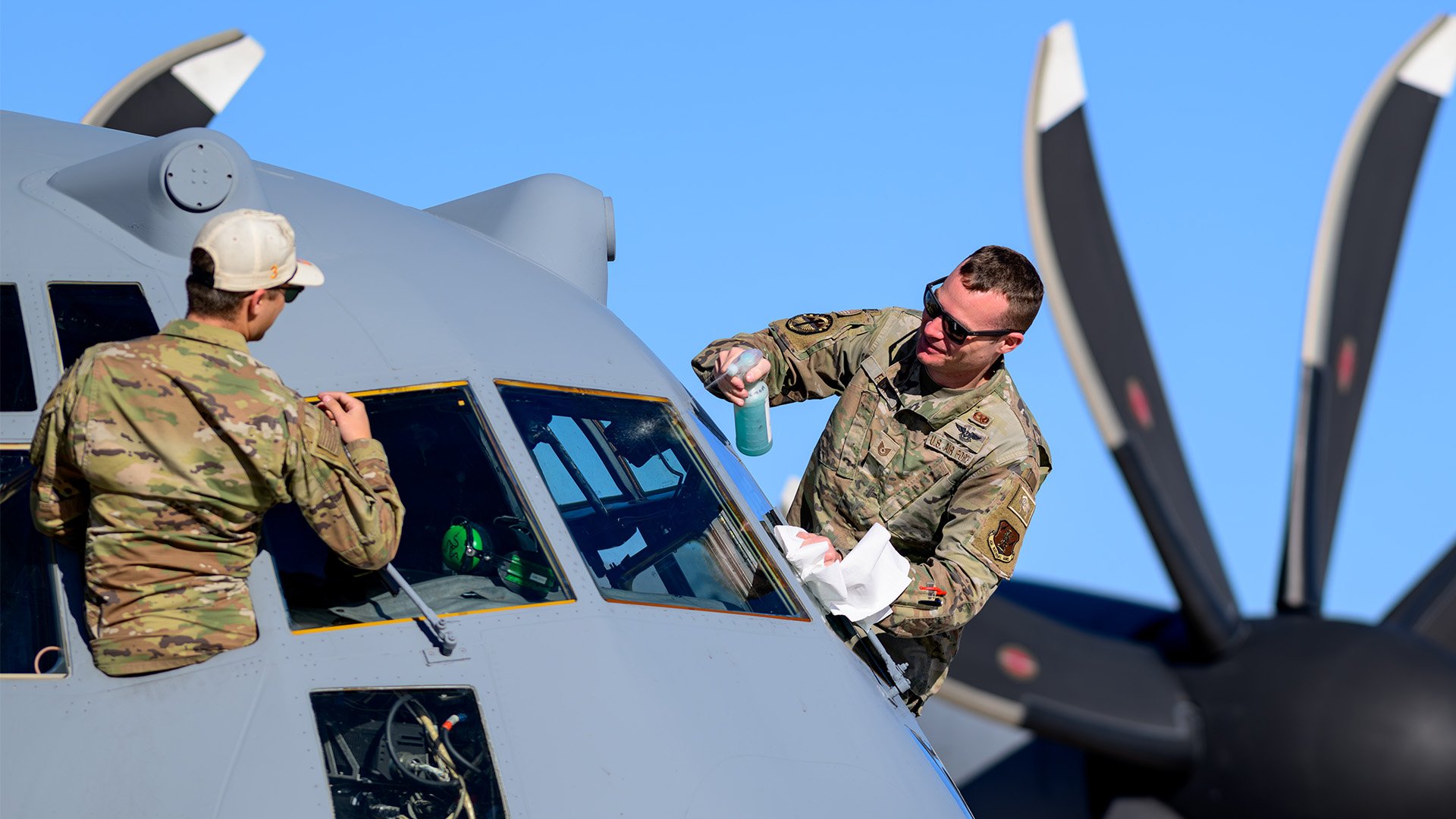 Airmen assigned to Cowboy Guard’s 153rd Airlift Wing clean the windshield of a C-130 Hercules, aircraft, during a Modular Airborne FireFighting System (MAFFS) training at Fort Huachuca, Arizona, on Feb. 13, 2025. The aircraft engage in MAFFS training, preparing aircrews for wildfire suppression efforts ahead of the upcoming fire season. The Wyoming Air National Guard is conducting the training alongside the California Air National Guard’s 146th Airlift Wing, enhancing joint wildfire response capabilities. (U.S. Army National Guard photo by Staff Sgt. Cesar Rivas)